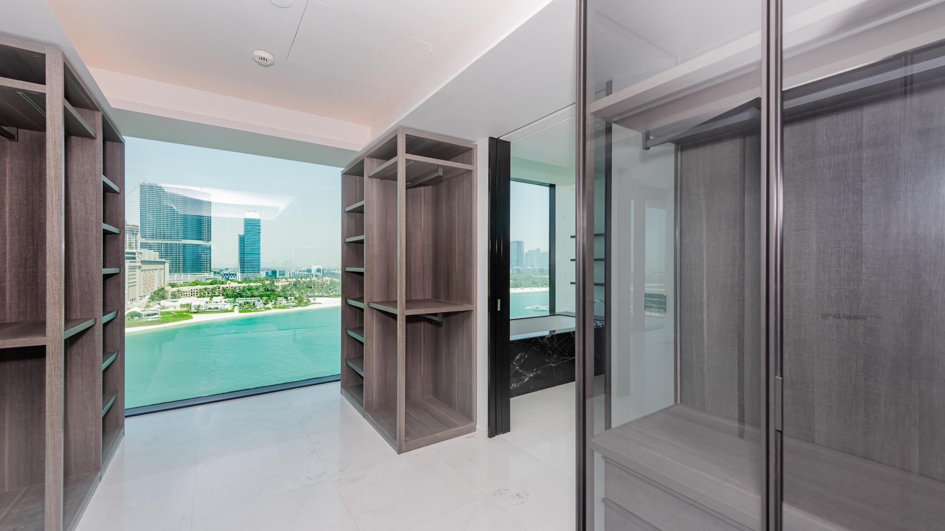 "Spacious walk-in closet with stunning sea views in Palm Jumeirah luxury apartment.",Luxury apartment interior with panoramic sea views at One at Palm Jumeirah