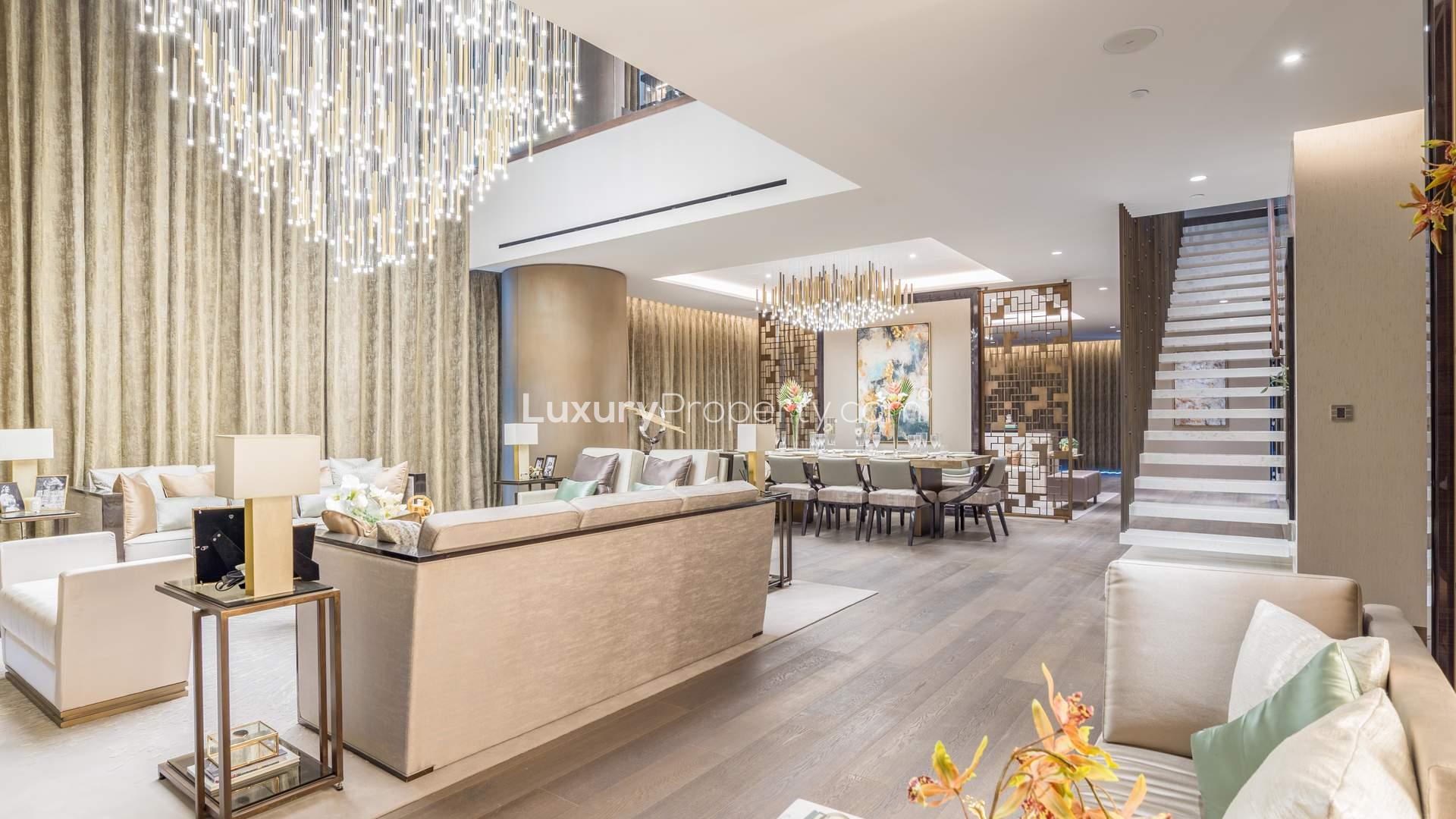 Luxurious living room in 4-bedroom Palm Jumeirah apartment with elegant decor and chandelier