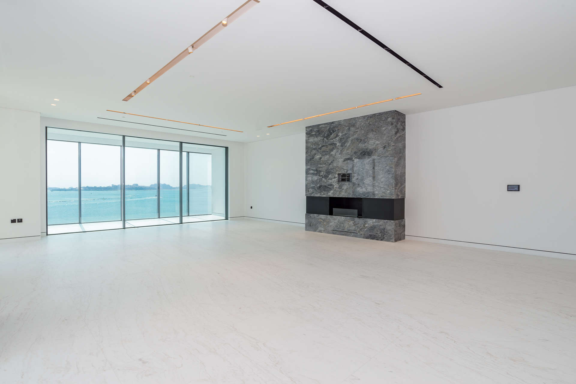 "Spacious living room with ocean view in Palme Couture apartment, Palm Jumeirah, Dubai.",Modern kitchen with marble countertops in Palme Couture, Palm Jumeirah apartment for sale