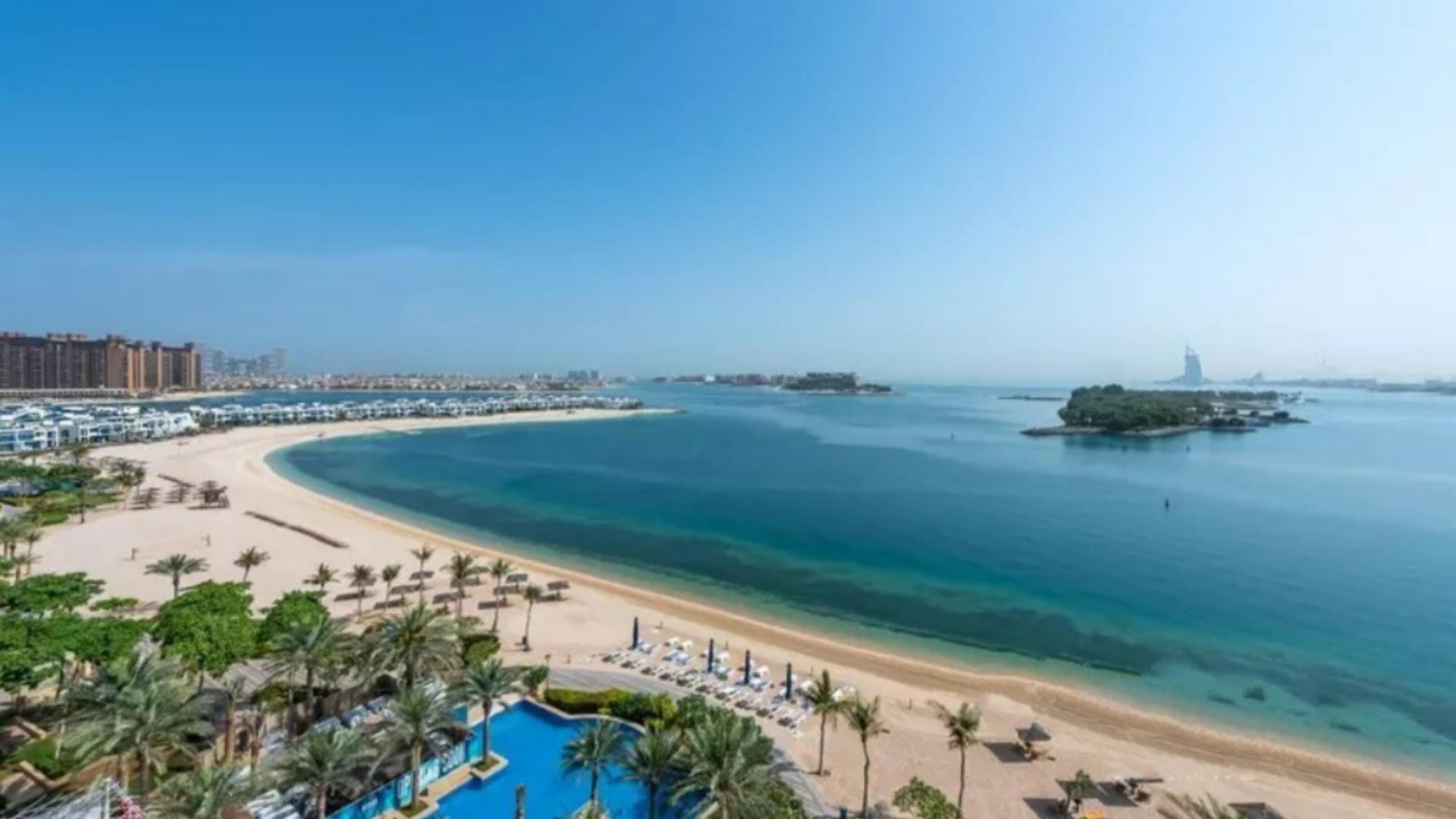 Luxurious Palm Jumeirah penthouse interior with marble floor and sea view balcony