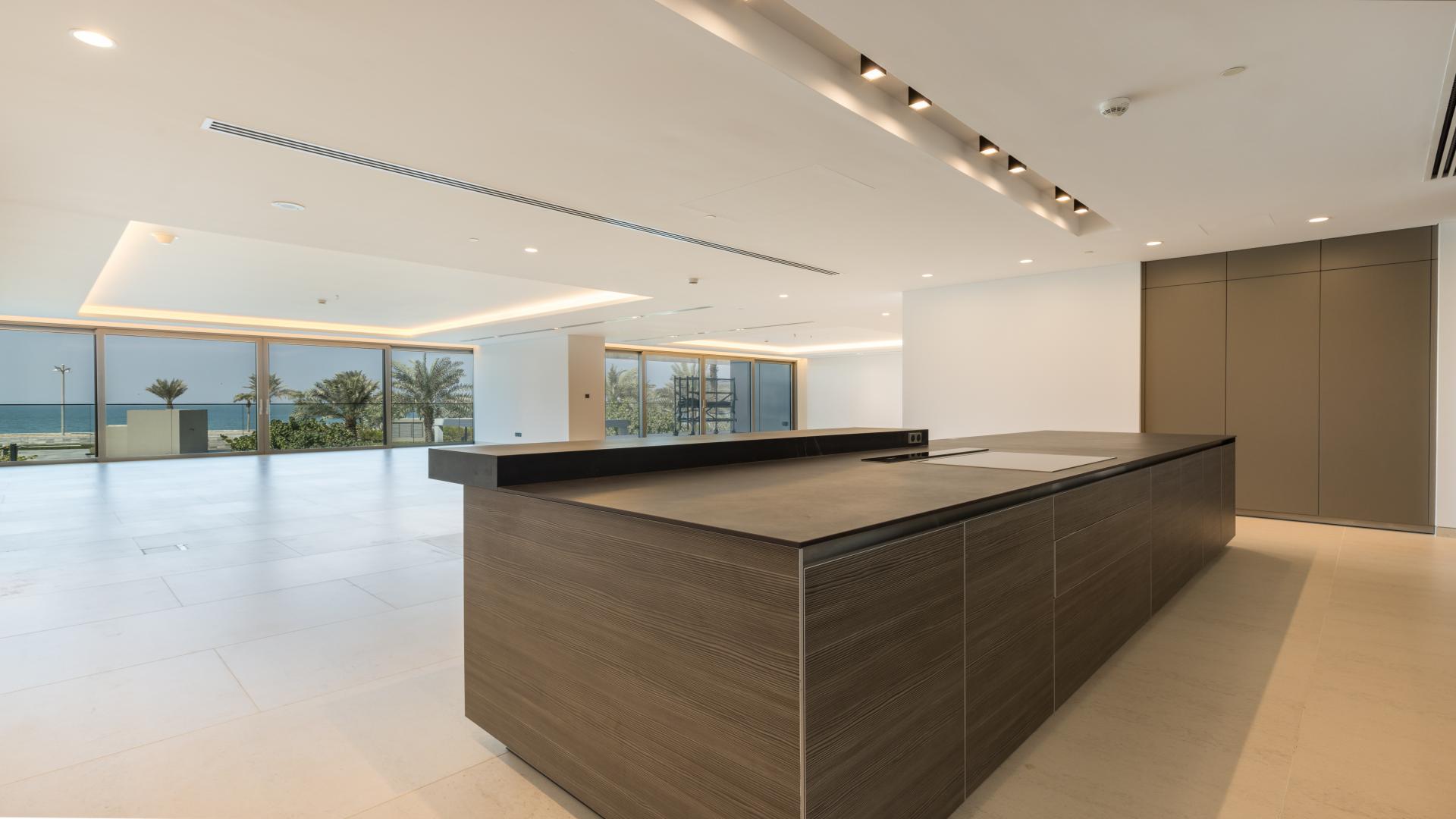 Penthouse view at W Residences, Palm Jumeirah with pool and lush garden scenery