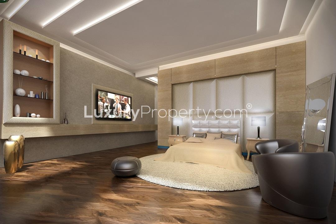Luxurious bedroom in Palm Jumeirah penthouse for sale, featuring modern furnishings and decor