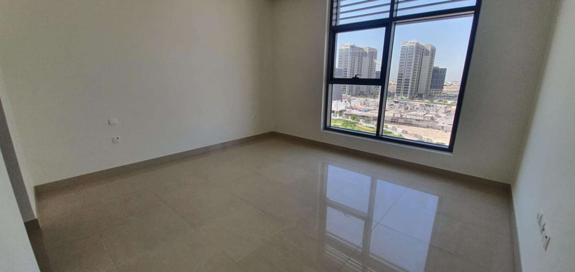 Spacious living area in luxury duplex apartment, Dubai Hills Estate, large windows, natural light