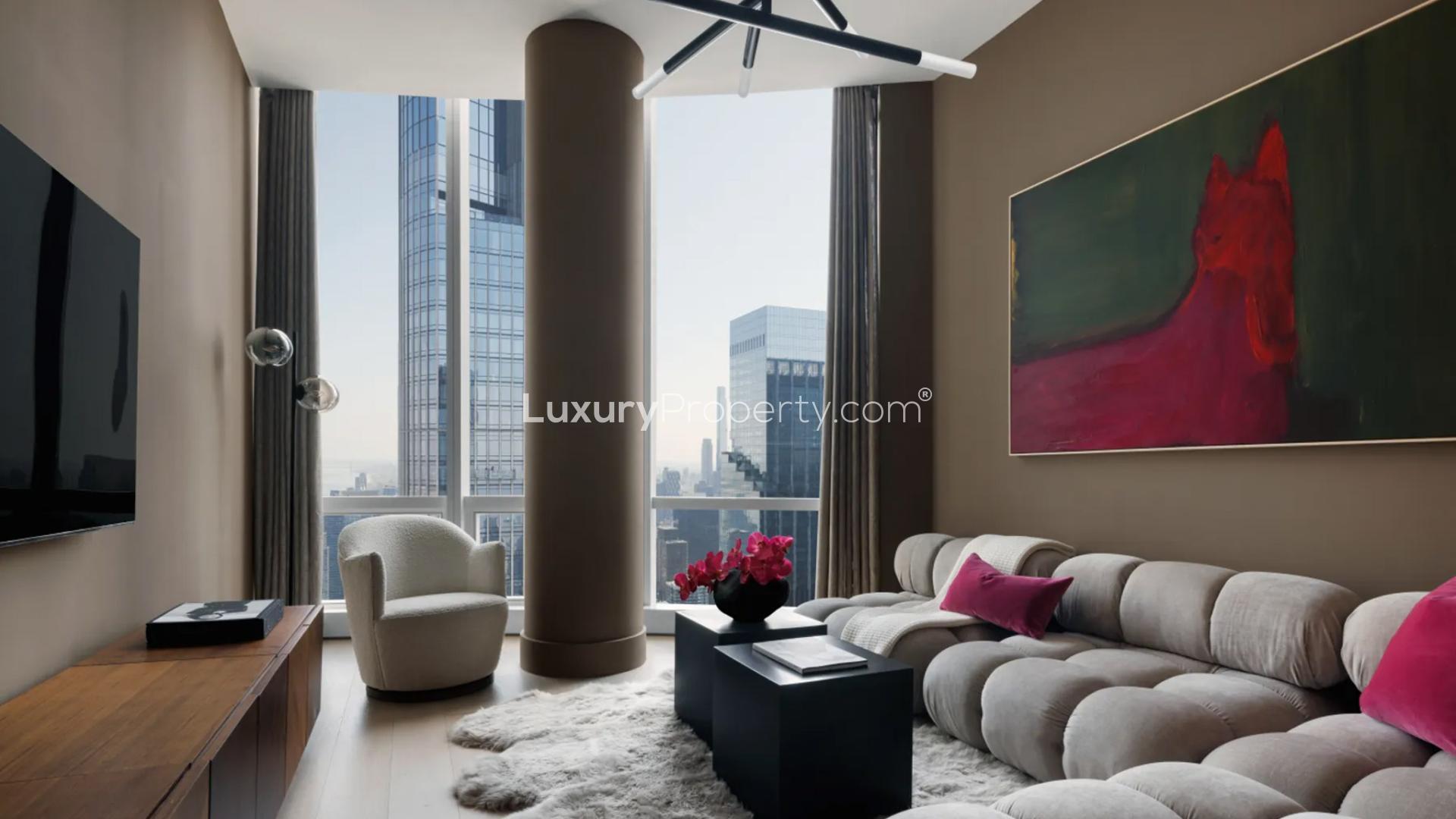 Luxurious penthouse living room with curved sofa, fireplace, and Manhattan skyline views