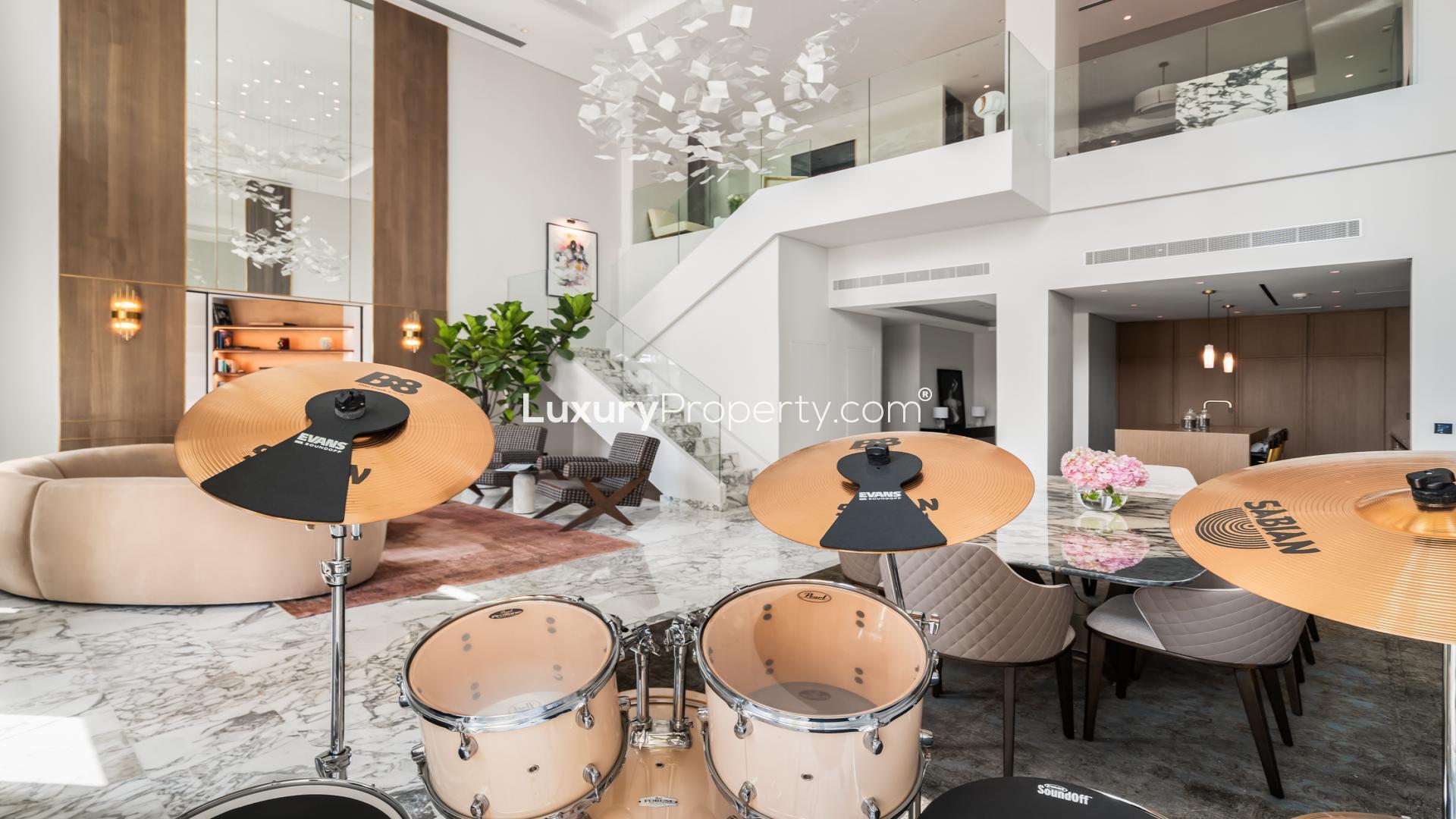 Luxurious penthouse living room with modern decor, high ceilings, and elegant furniture in Palm Jumeirah