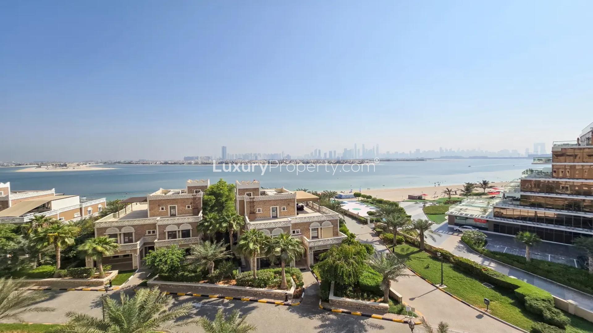 Luxurious living room in upgraded Palm Jumeirah penthouse, featuring modern decor and artwork