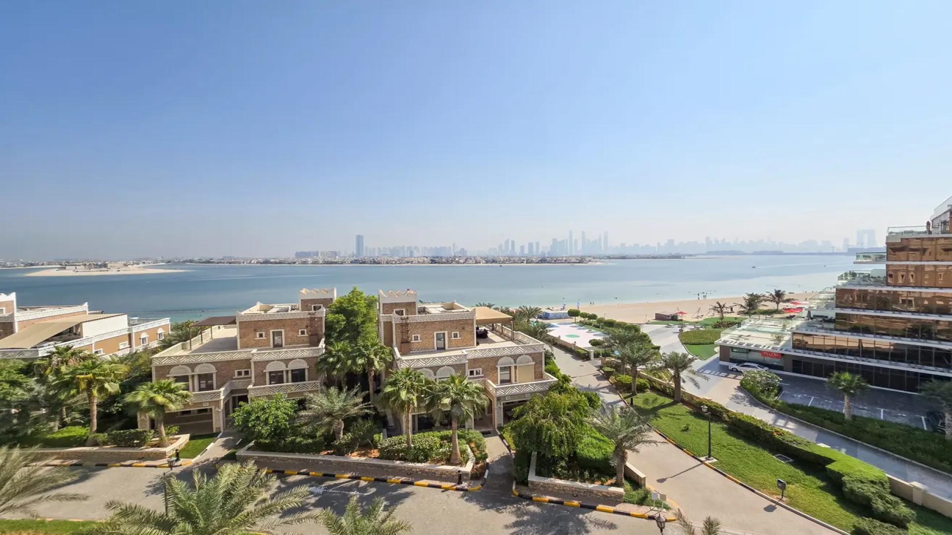 Luxurious living room in upgraded Palm Jumeirah penthouse, featuring modern decor and artwork