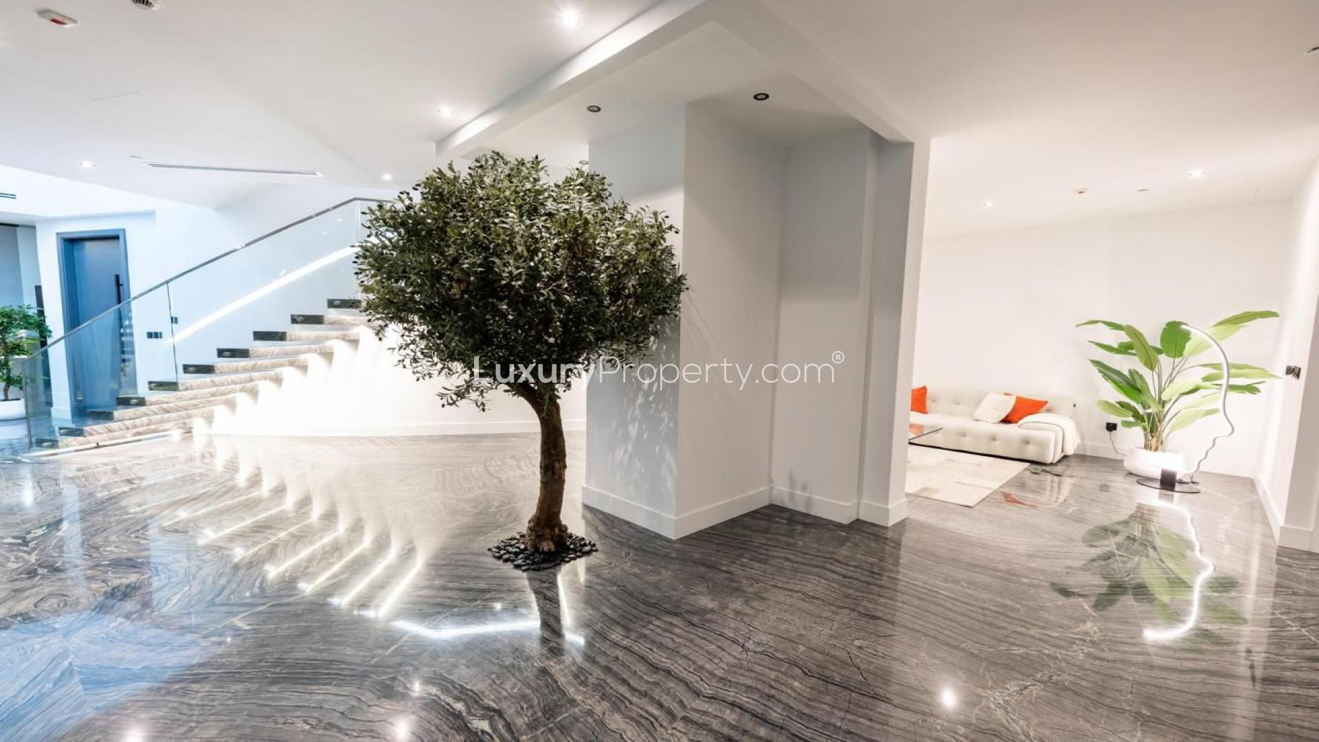 Luxurious penthouse interior with grand piano, floor-to-ceiling windows, Dubai Marina view