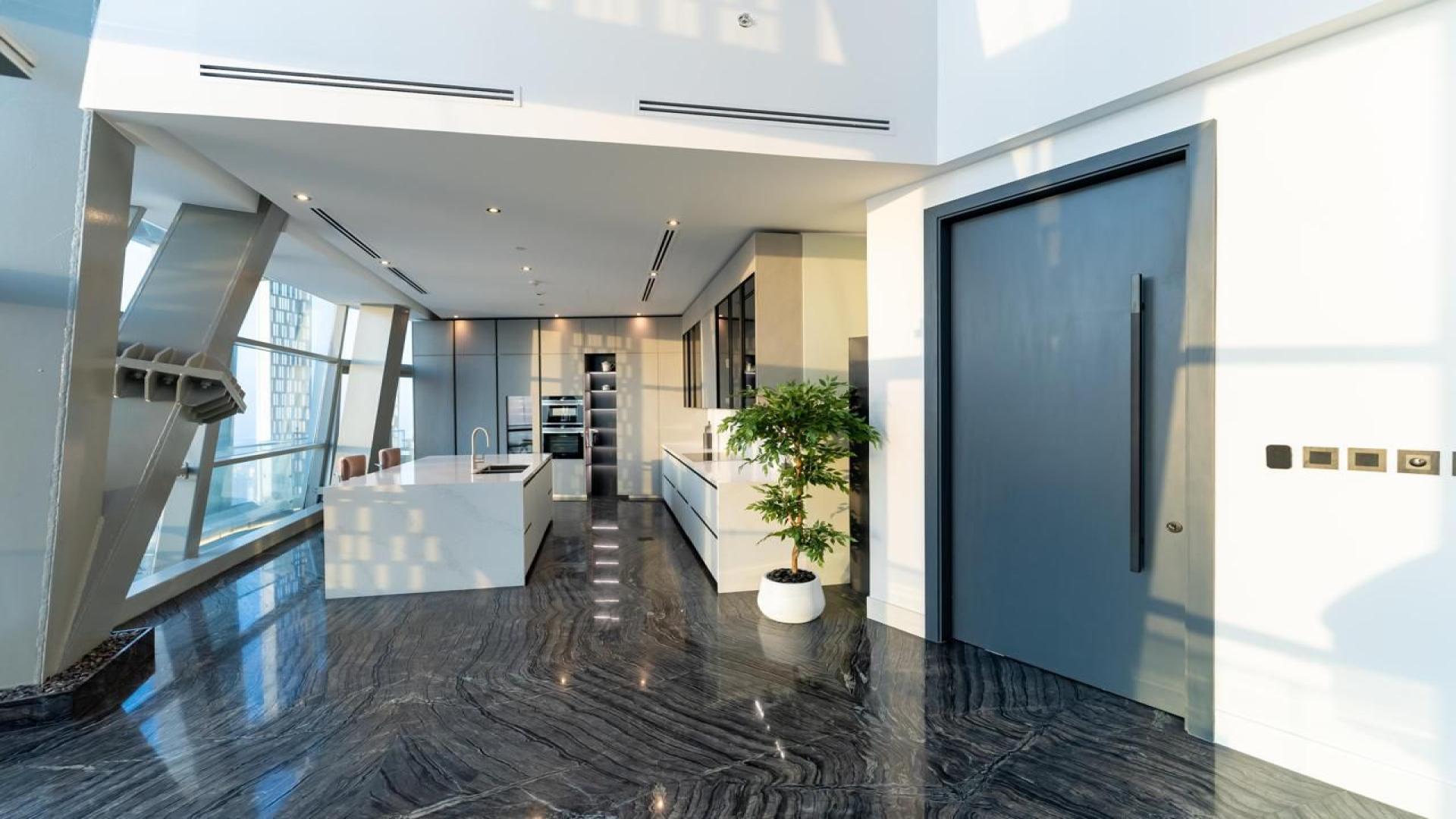 Luxurious penthouse interior with marble flooring and modern staircase in Dubai Marina