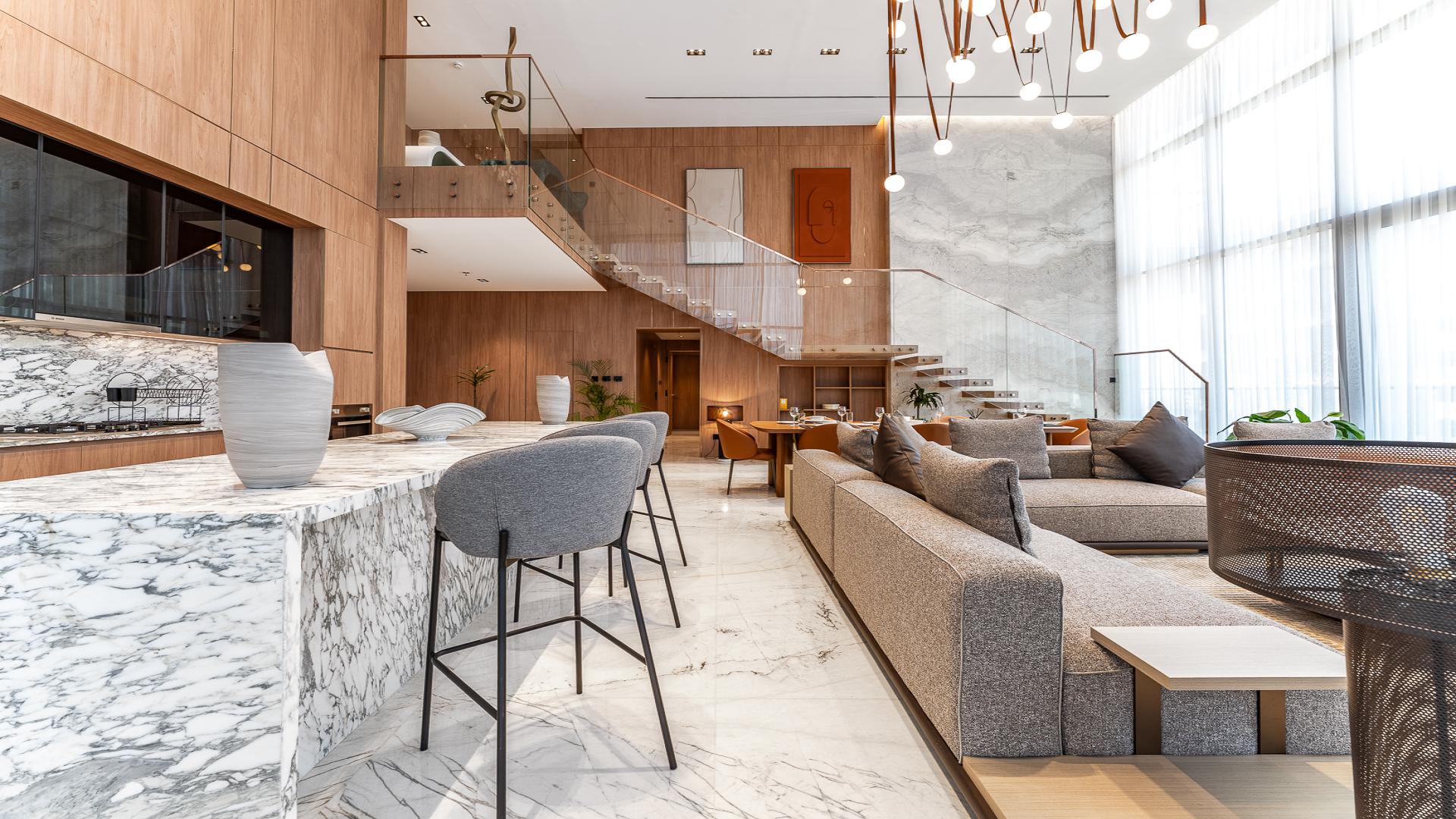 Luxurious duplex penthouse living area with city views in Business Bay, marble flooring