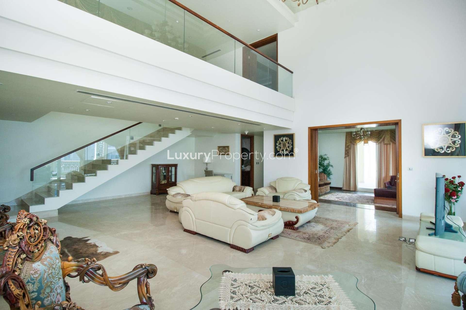 Modern kitchen in spacious Palm Jumeirah penthouse with wooden cabinets and sleek countertops