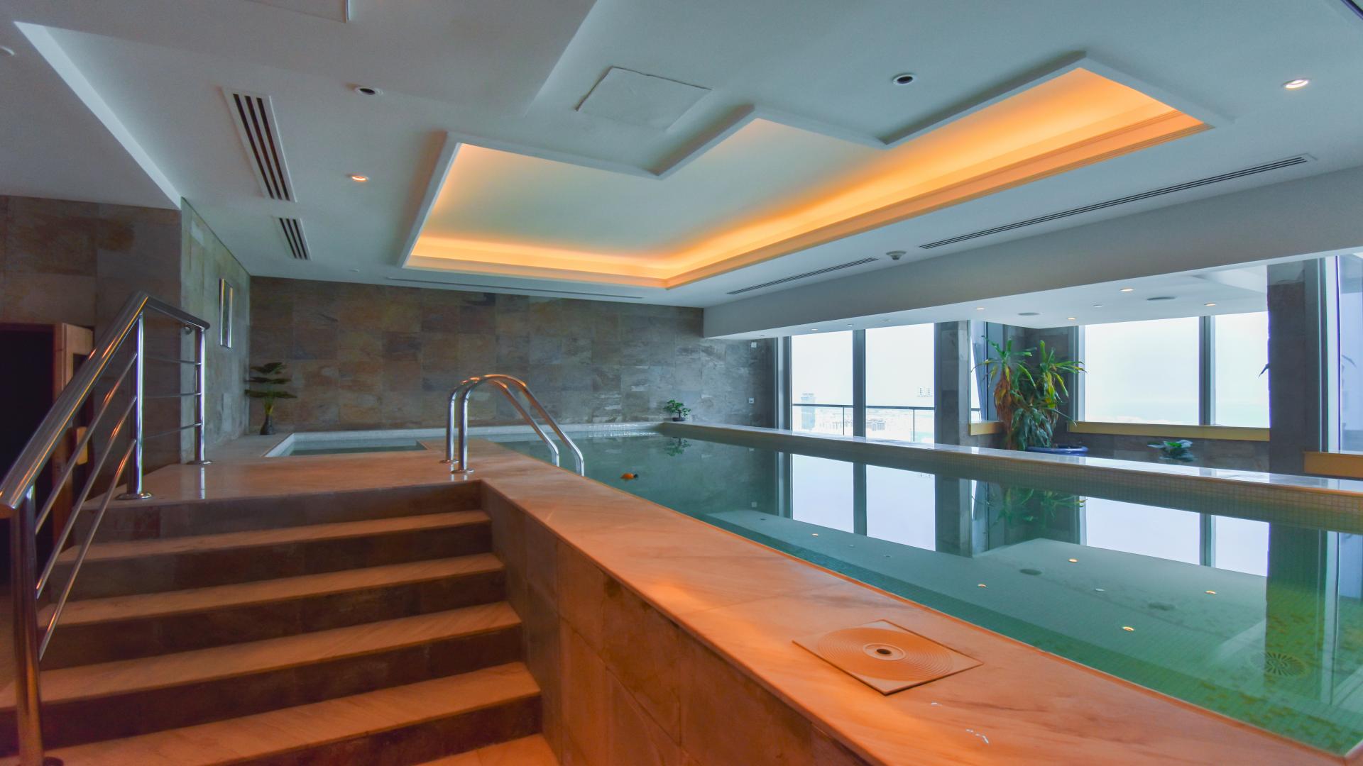 Luxurious living room in renovated Dubai Marina penthouse, Ocean Heights, with plush seating