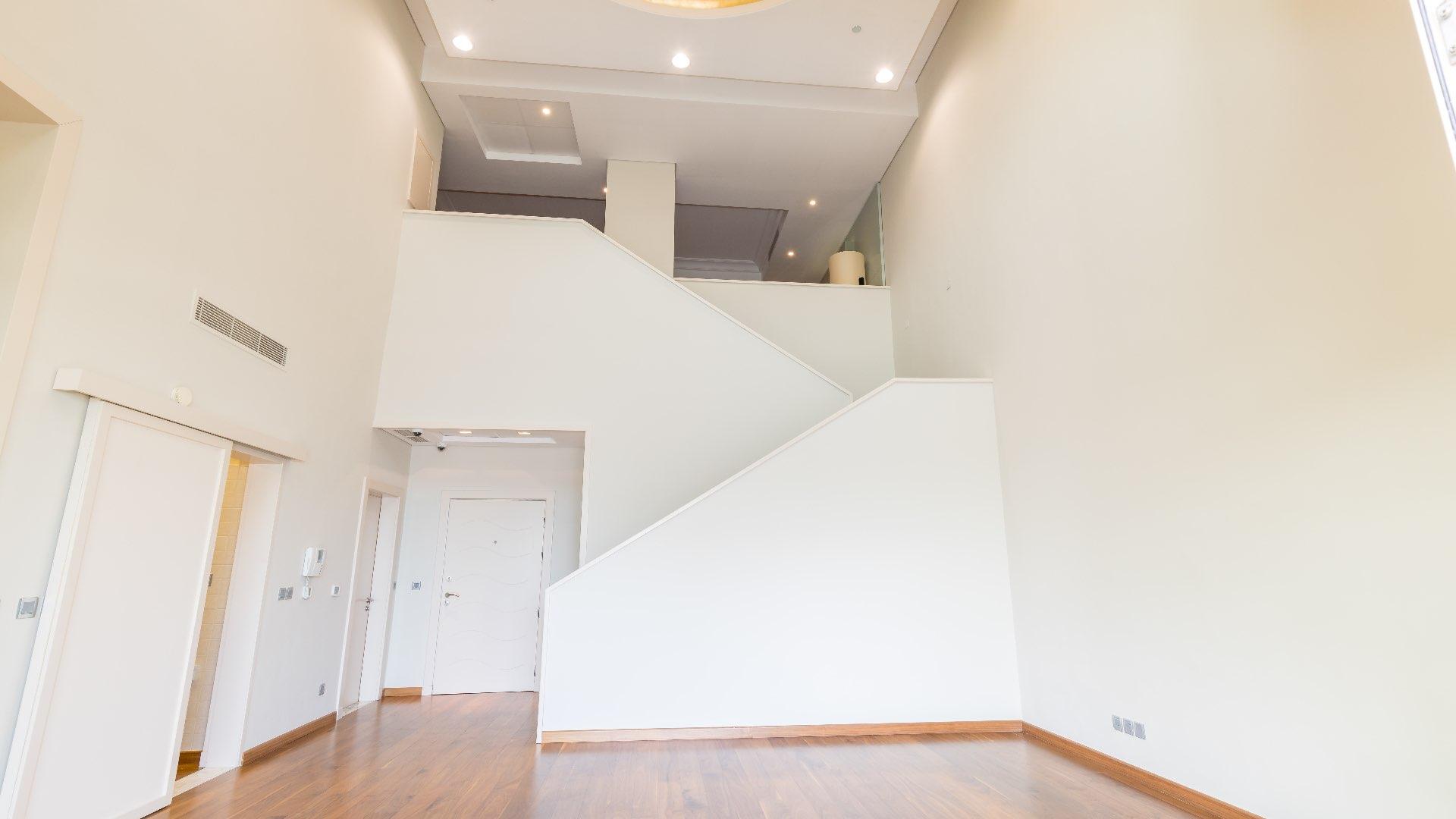 Luxurious penthouse interior with modern staircase in Shoreline Residences, Palm Jumeirah