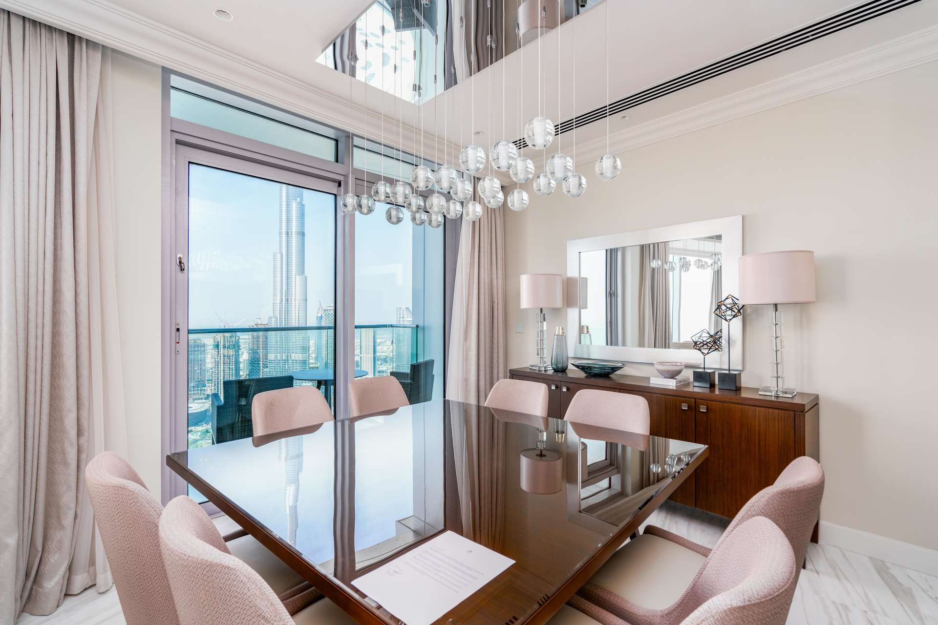 "Elegant hallway of 4-bedroom penthouse at The Address Fountain Views, Downtown Dubai.",Dining area in 4-bedroom penthouse, The Address Fountain Views, Downtown Dubai, with city view