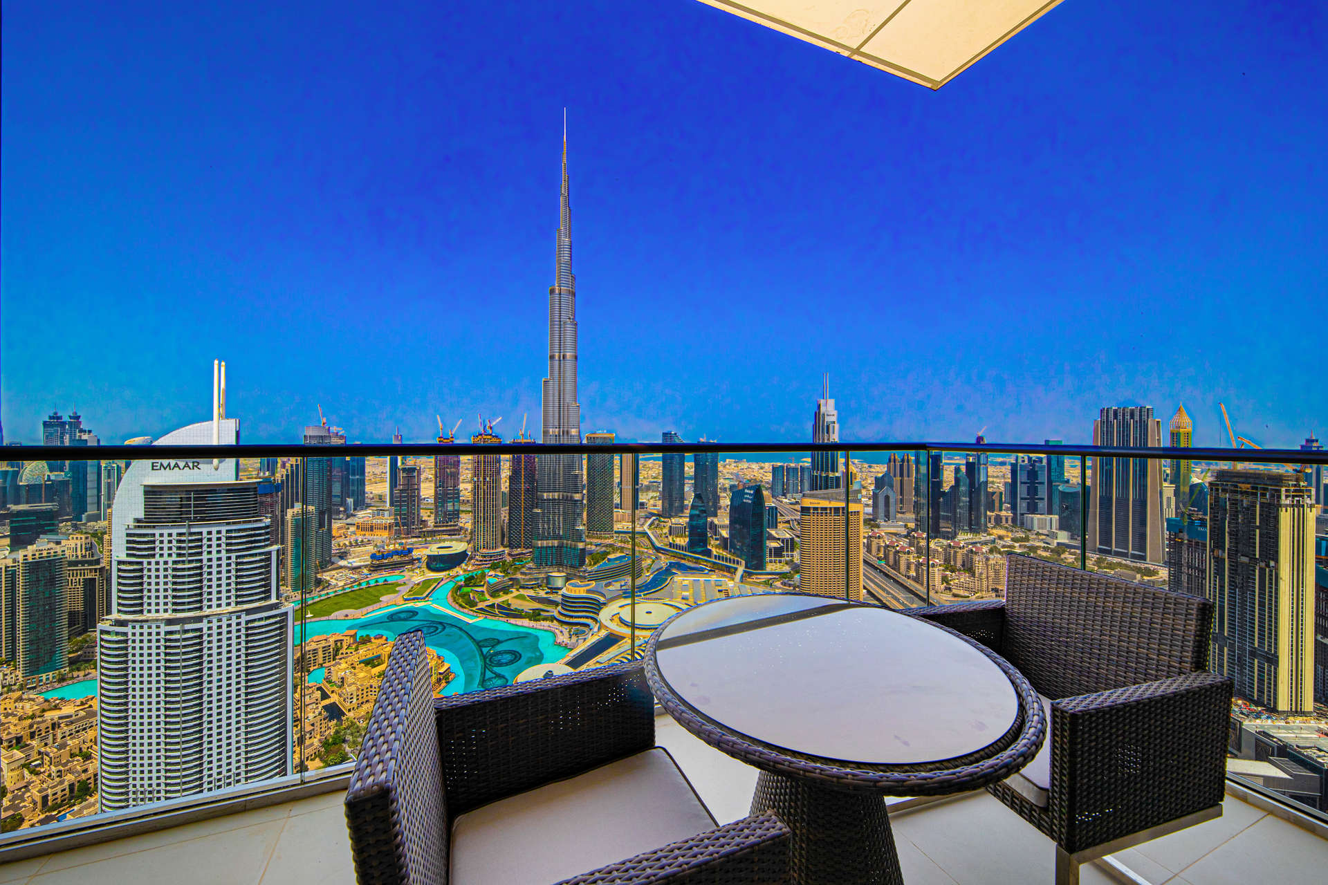 Luxury penthouse balcony view of Burj Khalifa, Downtown Dubai skyline, outdoor seating area