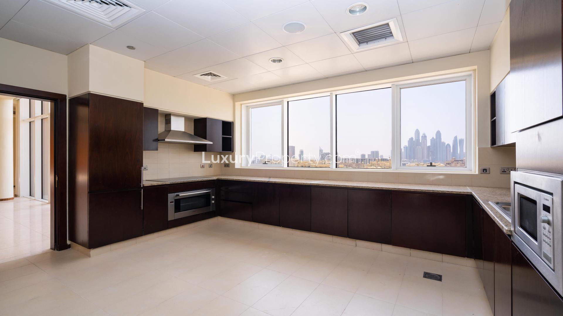 Spacious living area in Tiara Penthouse, Palm Jumeirah, with large windows and tile flooring
