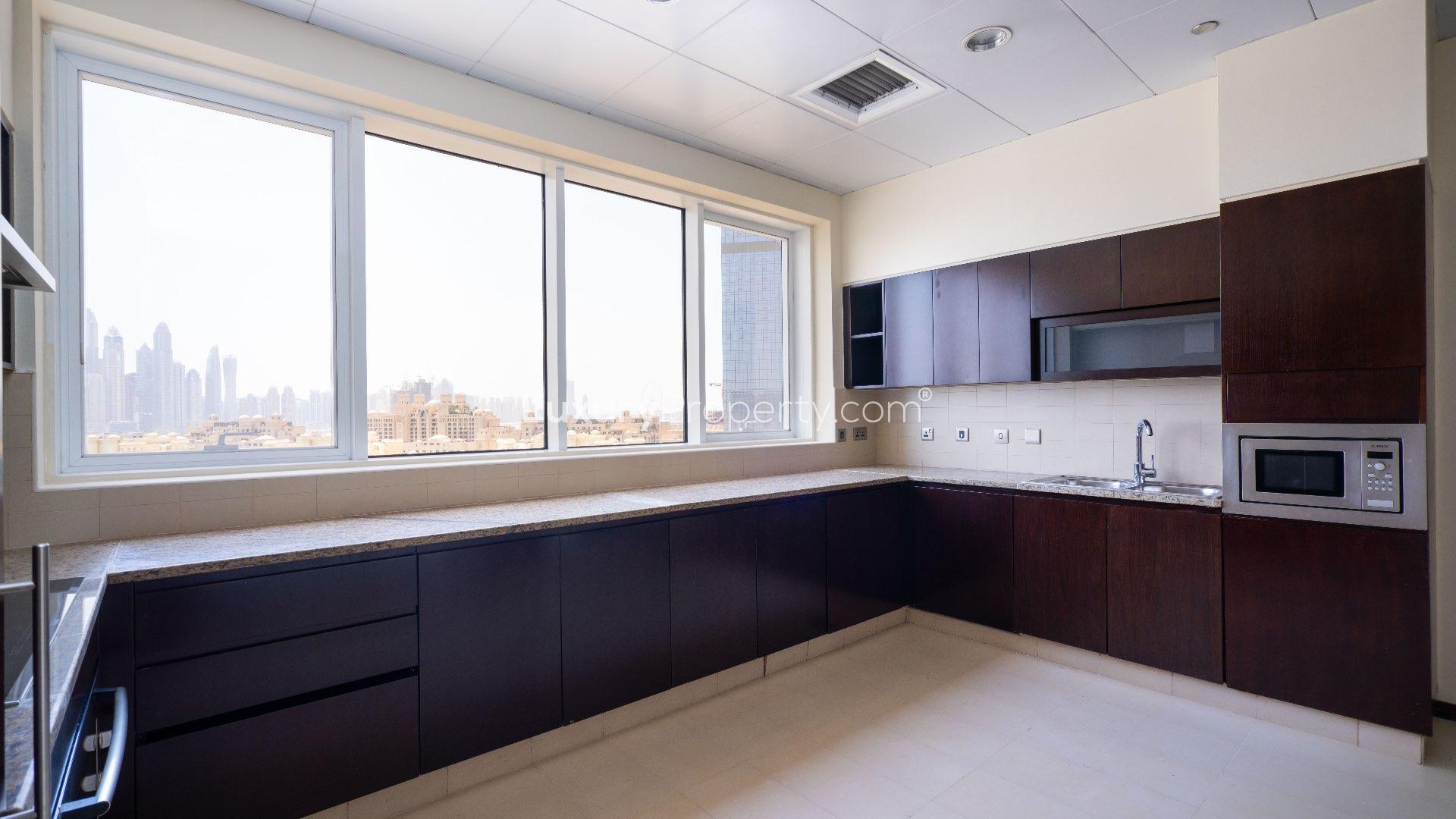 Modern kitchen in a spacious Tiara Penthouse, Palm Jumeirah, with city skyline views