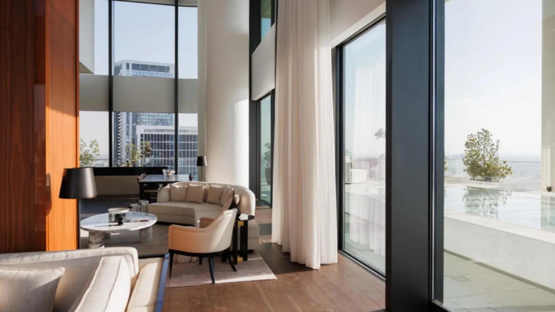 Luxurious living room in Business Bay penthouse, Dorchester Collection, with modern decor and artwork