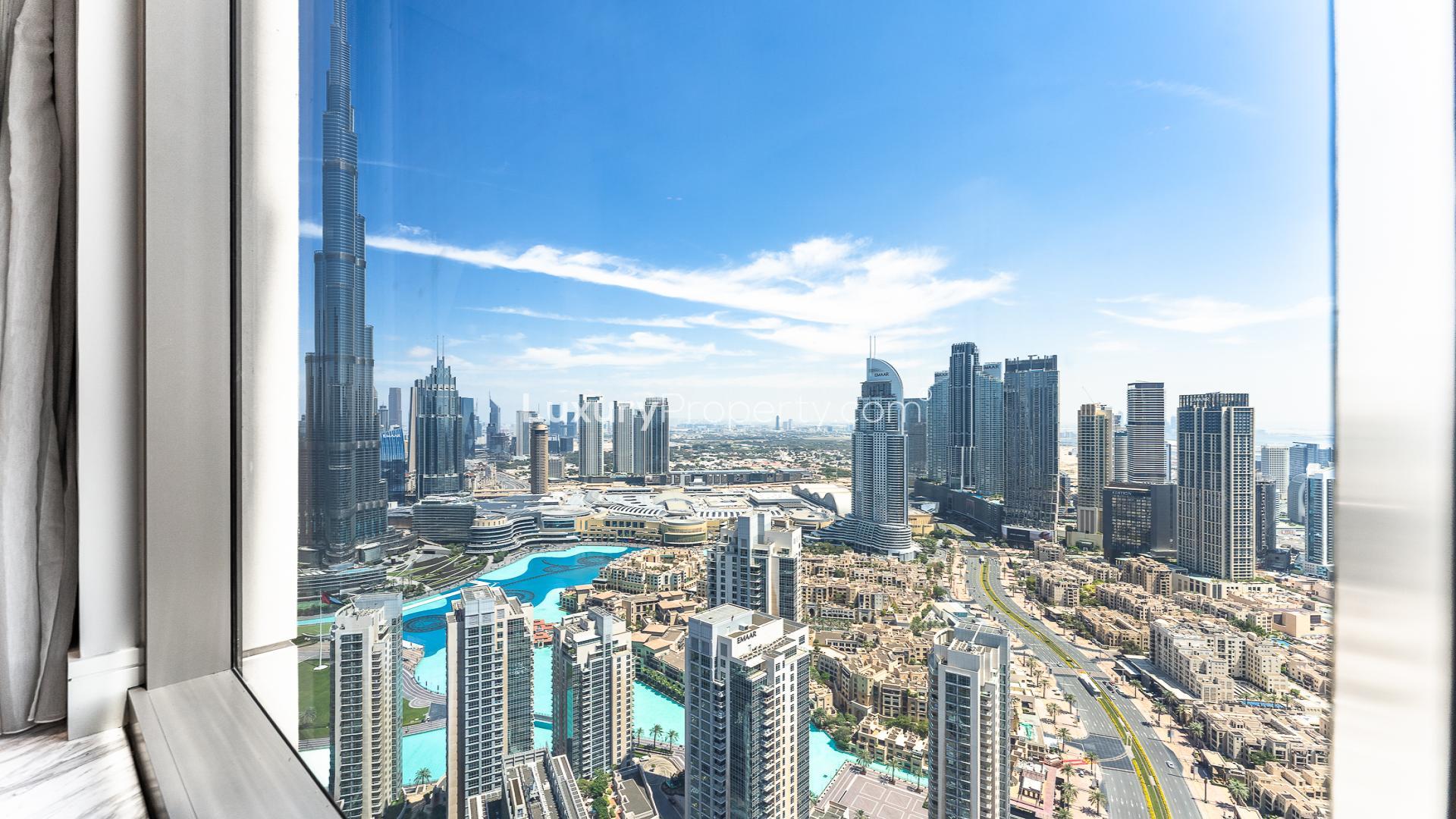 Luxurious penthouse living area with city view, marble floors, and modern furnishings in Dubai