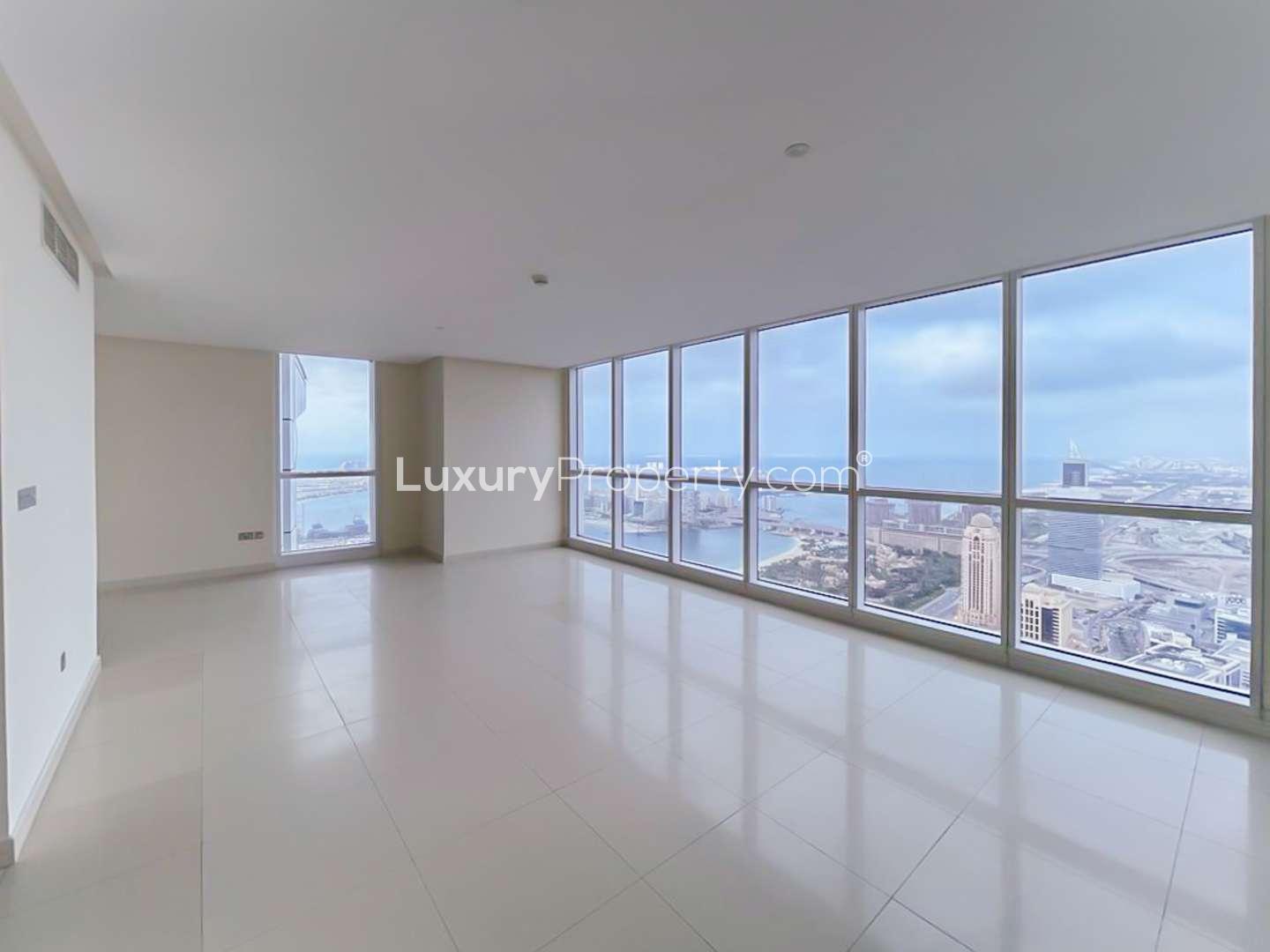 Spacious penthouse living area with large windows offering stunning Dubai Marina views