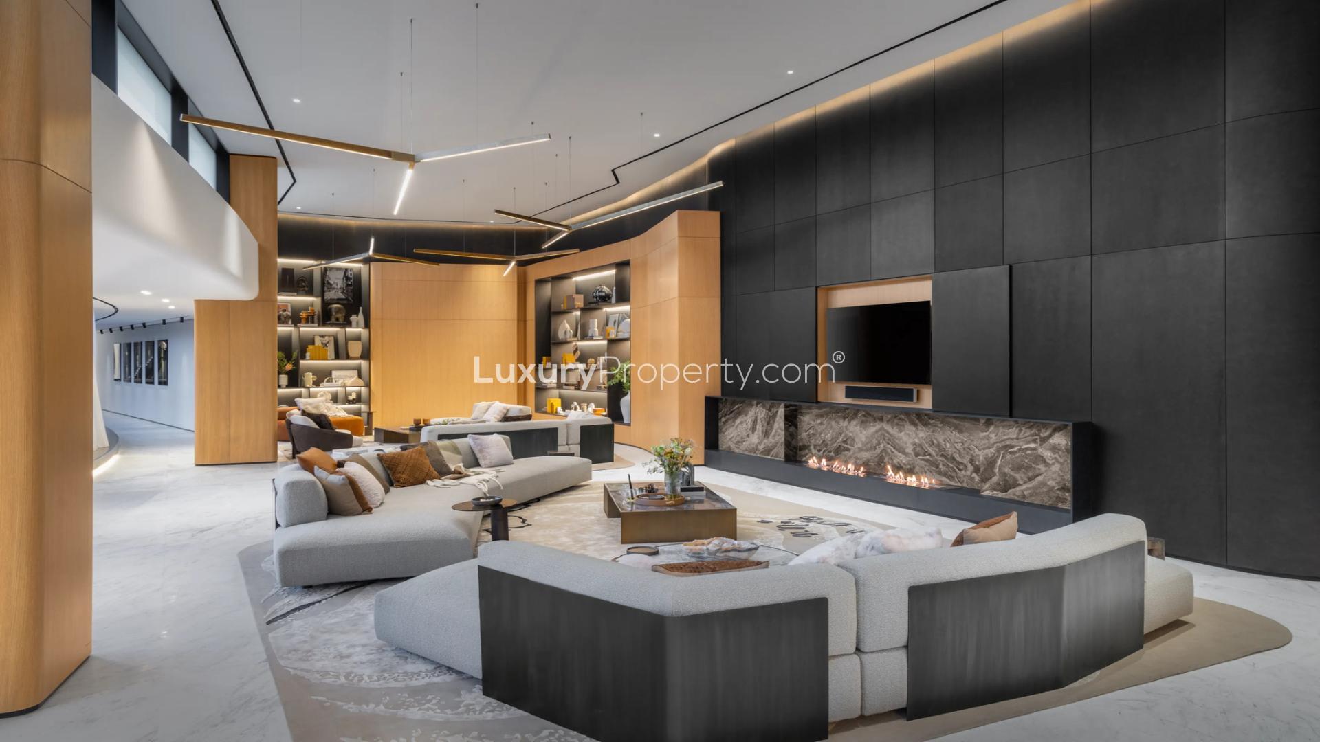 Luxurious living room in curved design penthouse, Business Bay, featuring modern decor and fireplace