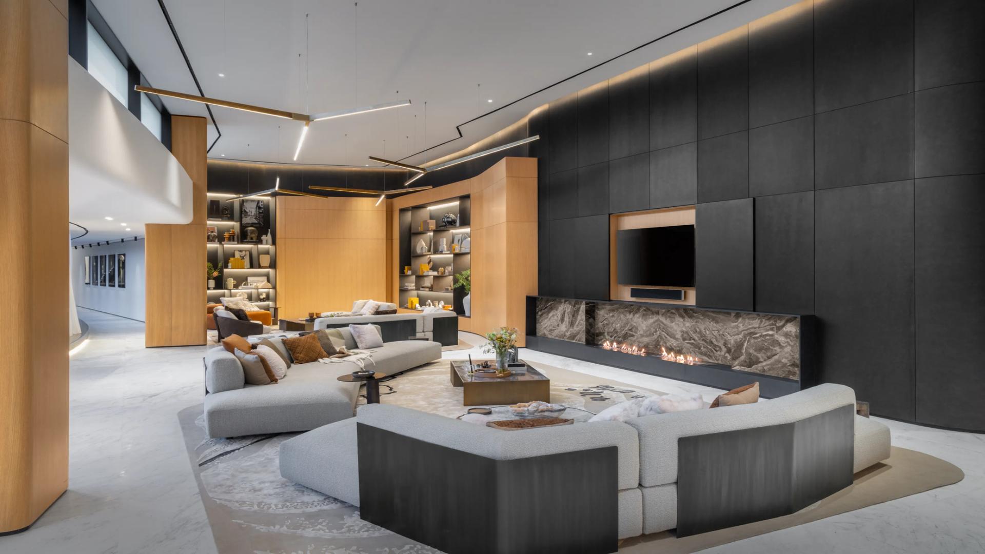 Luxurious living room in curved design penthouse, Business Bay, featuring modern decor and fireplace