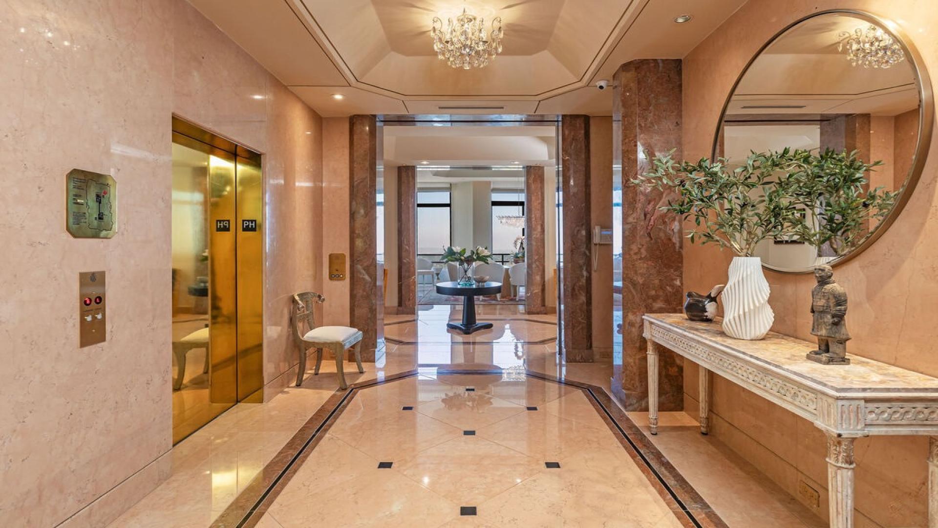 Luxurious Los Angeles penthouse living room with grand piano and spiral staircase