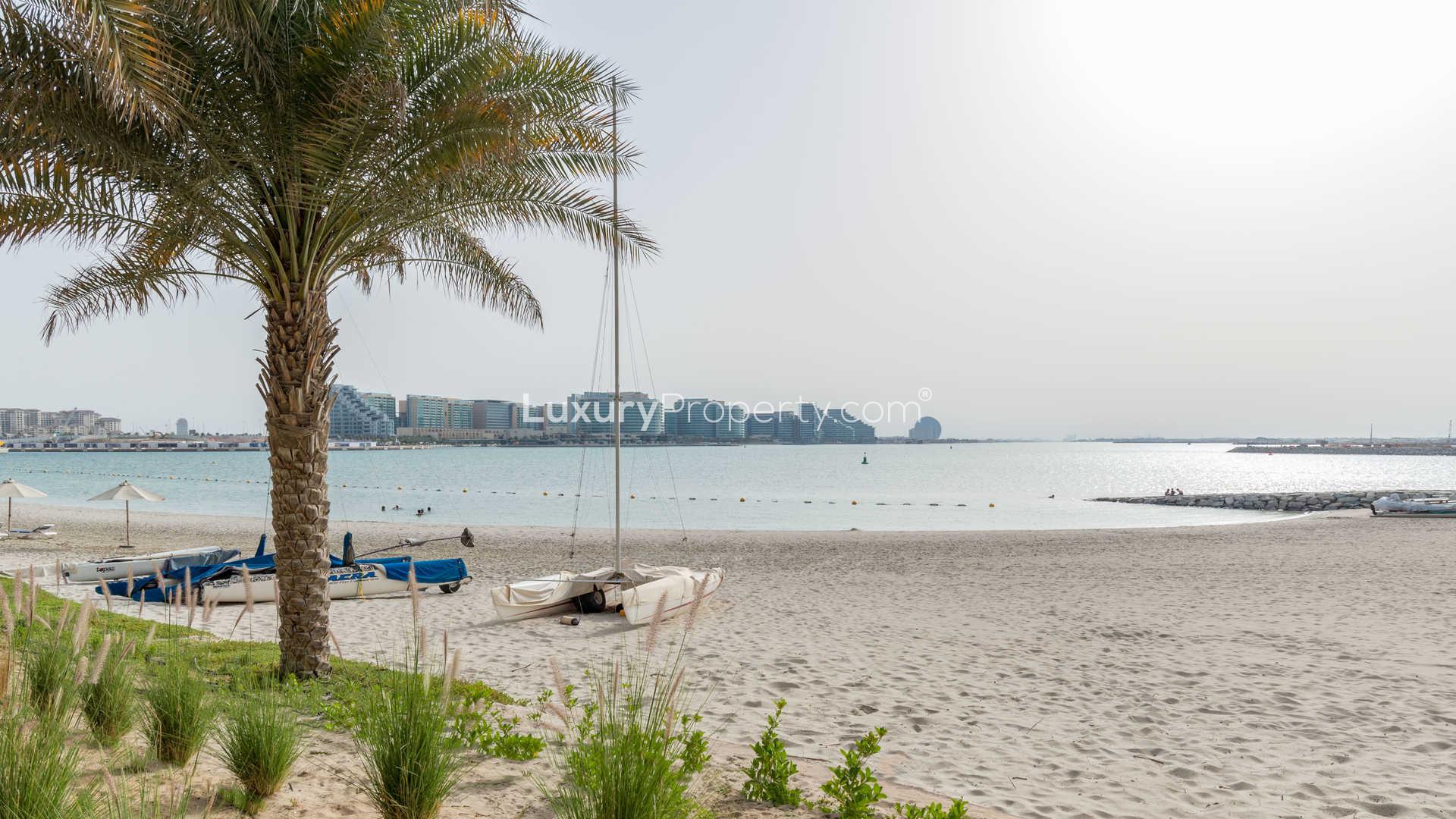 Beachfront penthouse exterior at Zeina Al Raha, Abu Dhabi, with palm trees and balconies