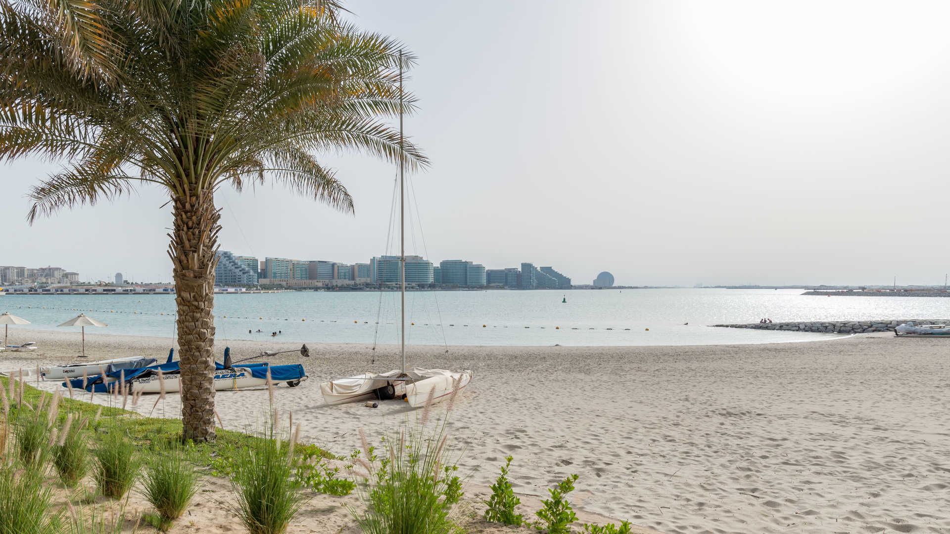 Beachfront penthouse exterior at Zeina Al Raha, Abu Dhabi, with palm trees and balconies