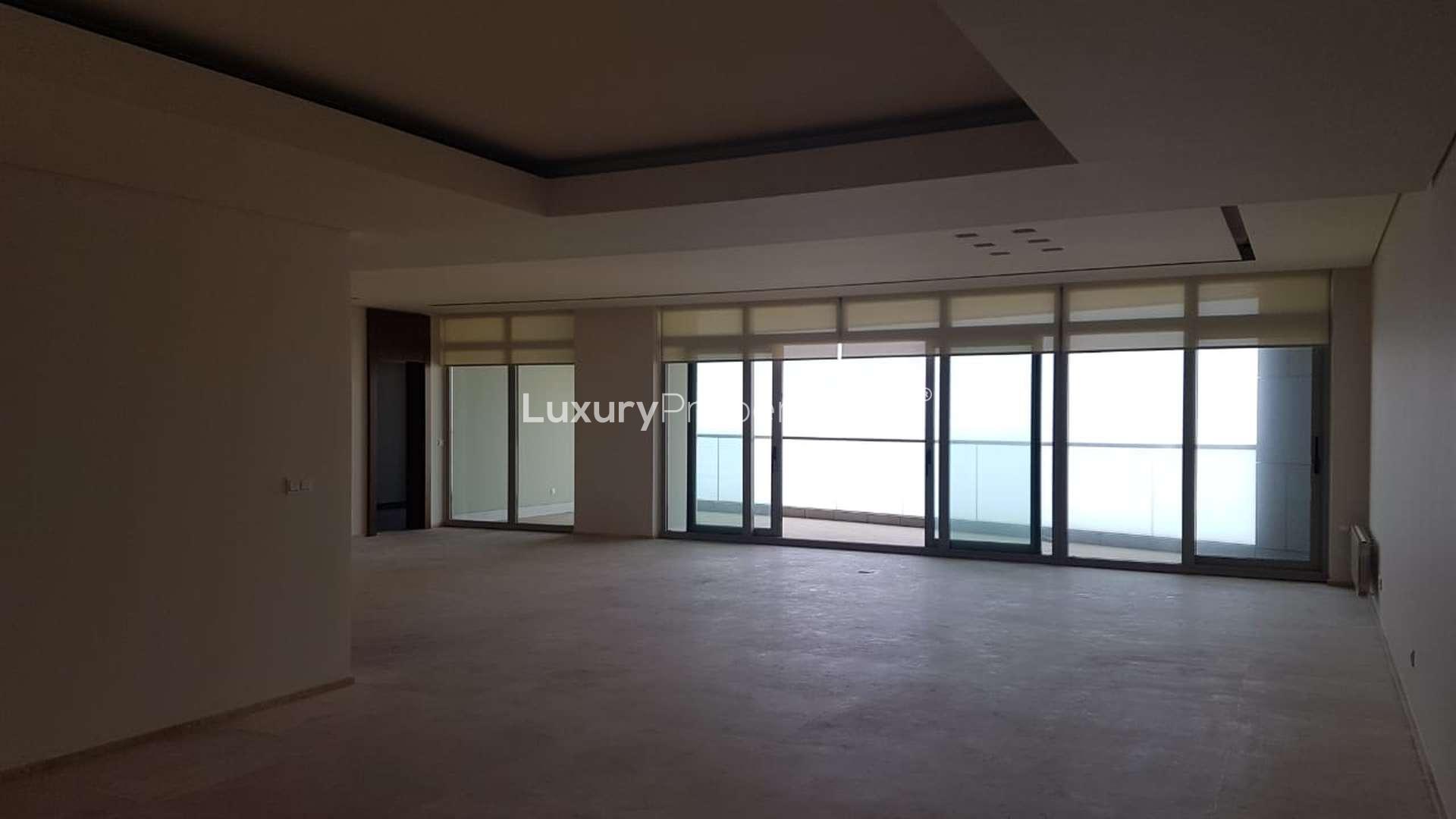 "Entryway of stunning penthouse for sale at Bay Tower, Minet El Hosn, Beirut.",Spacious living area with floor-to-ceiling windows, Bay Tower penthouse, Minet El Hosn, Beirut