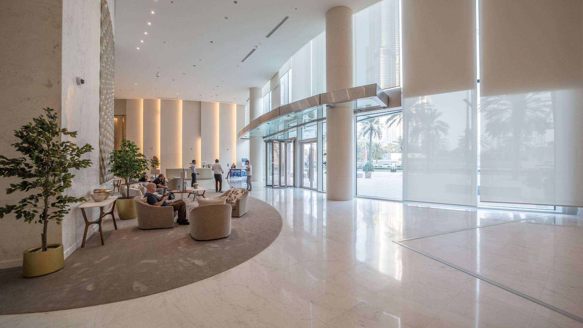 "Stunning facade of Burj Vista penthouse, Downtown Dubai luxury four-bedroom duplex for sale.",Luxurious lobby of Burj Vista penthouse, Downtown Dubai, featuring modern design and elegant seating