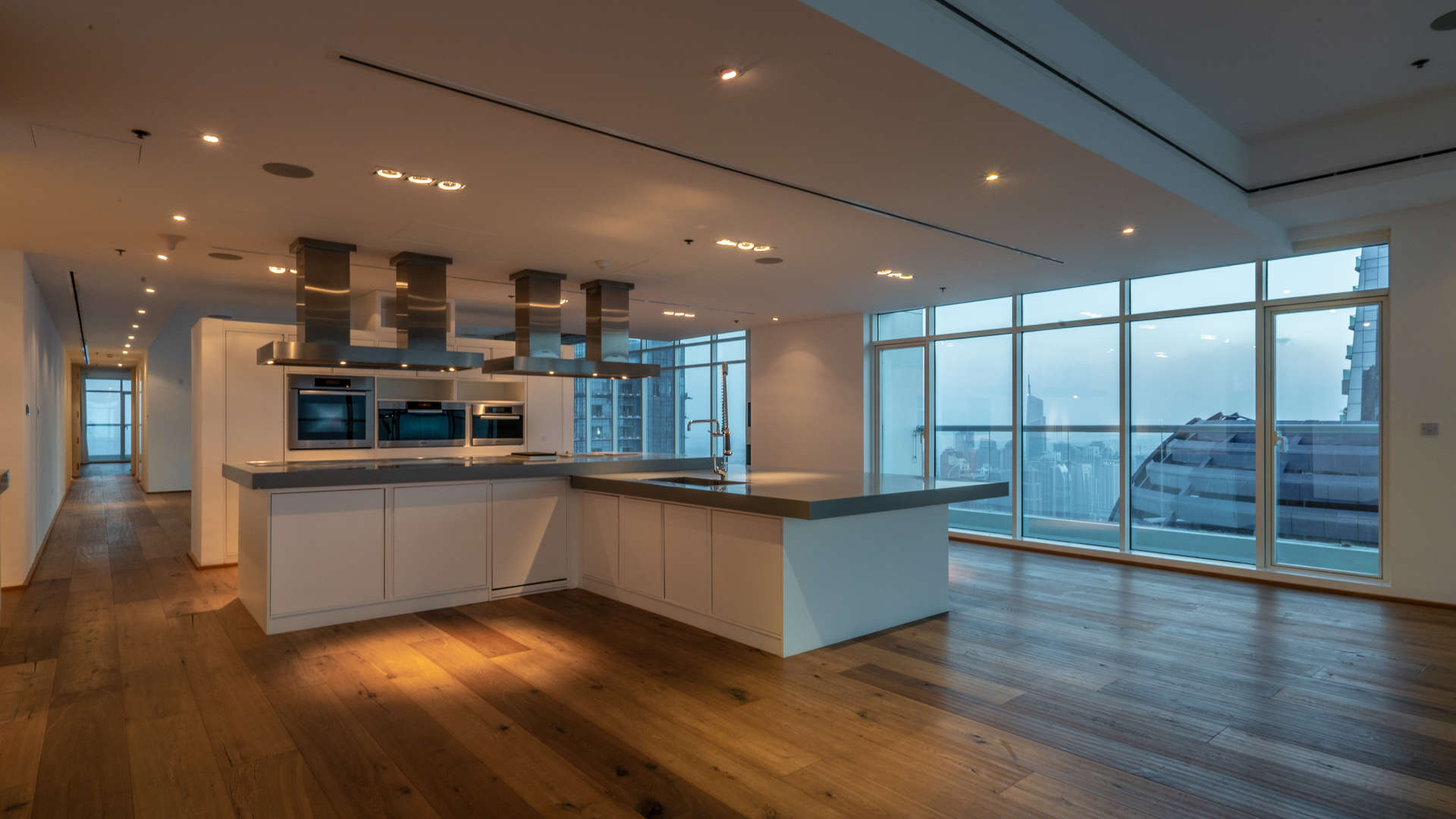 Aerial view of Dubai Marina skyline at night, showcasing luxury high-rises and waterfront