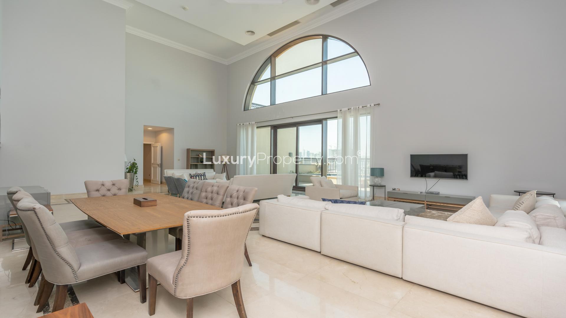 "Stunning sea and skyline view from The Royal Penthouse, Fairmont Palm Jumeirah.",Luxurious living room in Fairmont Penthouse, Palm Jumeirah, with elegant decor and sea view