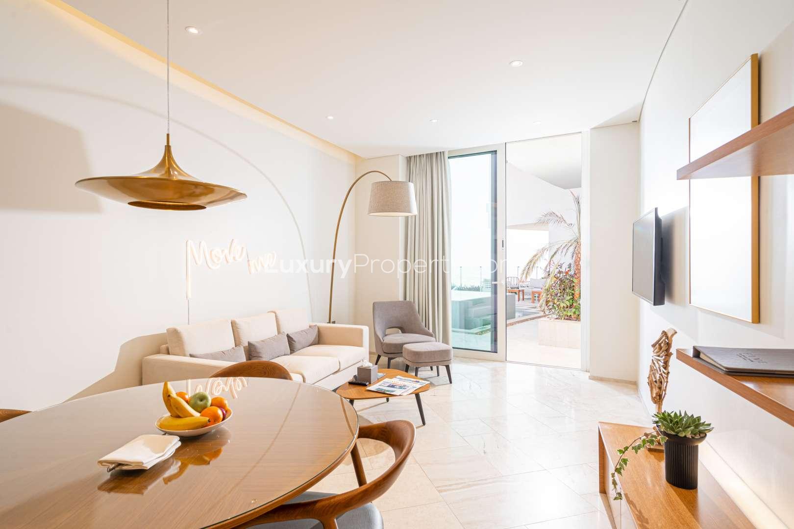 Modern kitchen in 4-bedroom penthouse, Jumeirah Village Circle, with sleek cabinetry and appliances