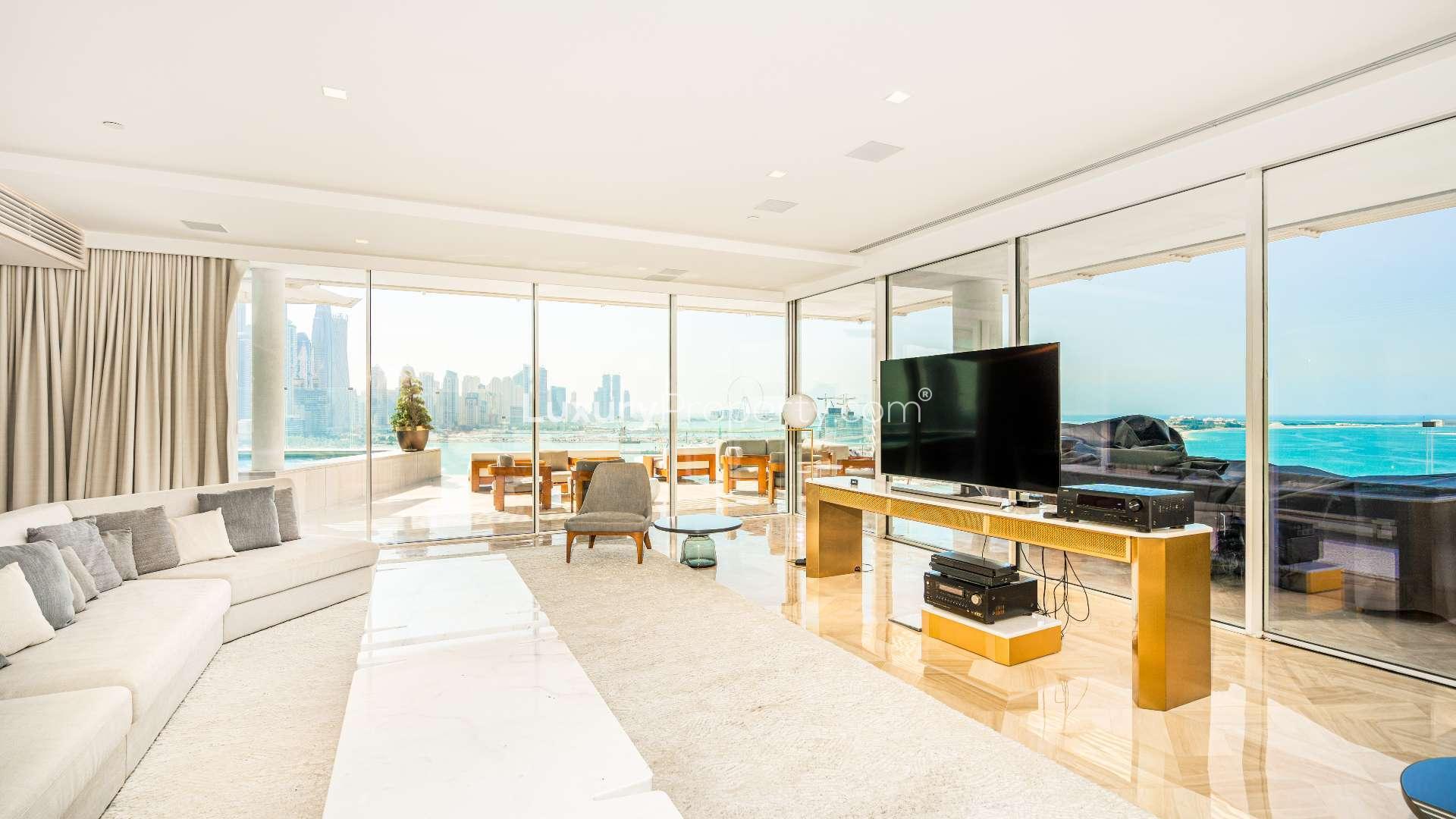 Luxurious penthouse living room with sea view, Palm Jumeirah, featuring modern decor and TV
