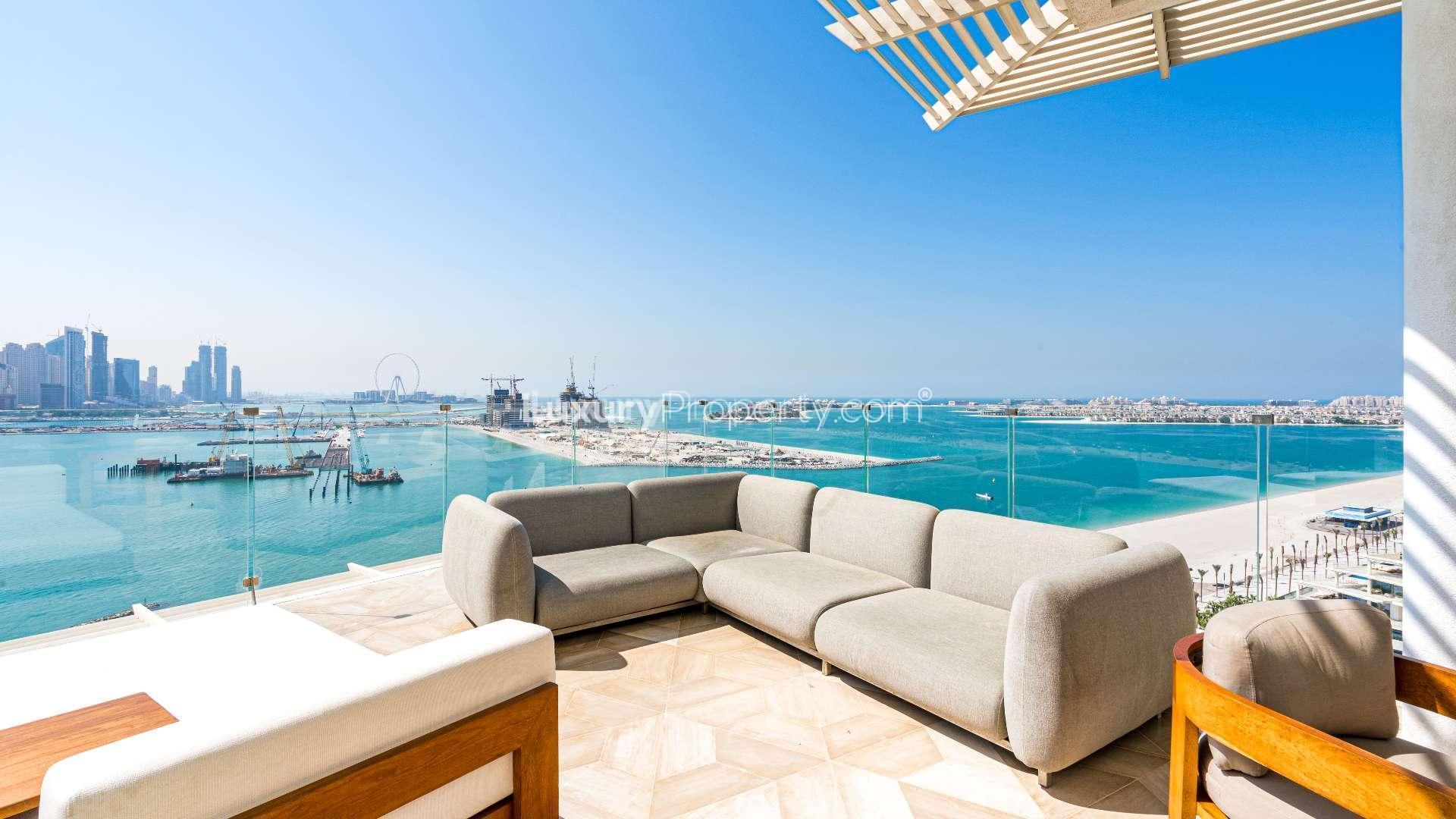 Luxurious Palm Jumeirah penthouse terrace with sea and skyline views, featuring elegant seating