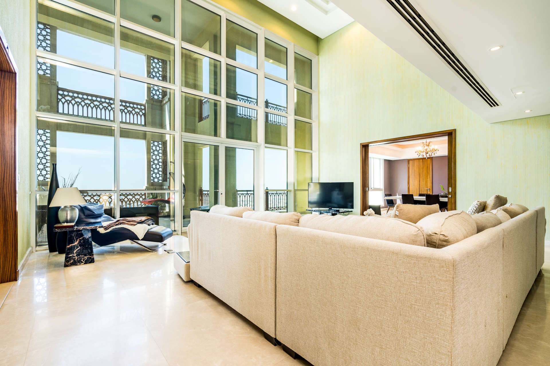 Interior view of luxury penthouse with large windows at Palm Jumeirah, Marina Residences