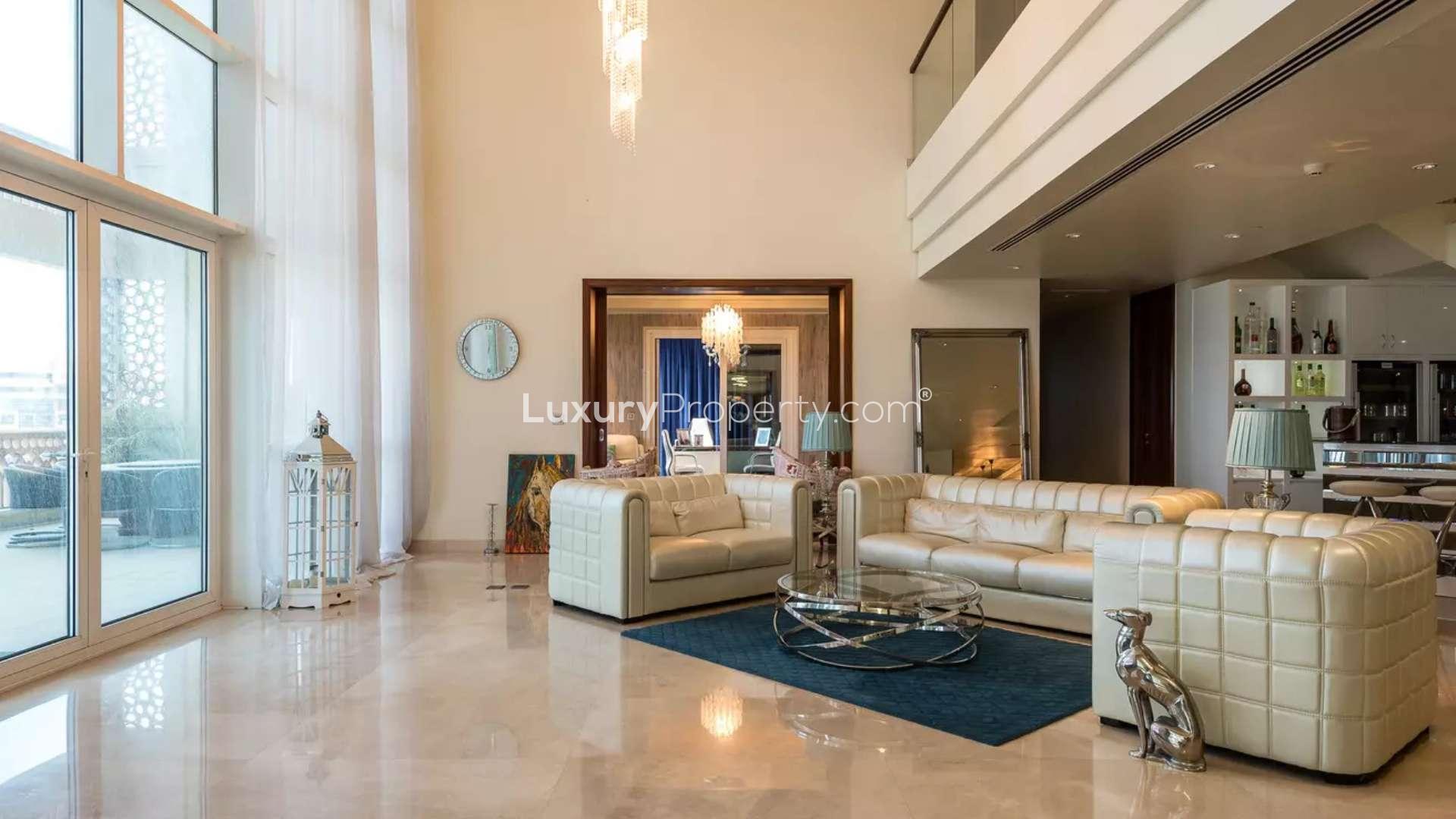 Luxurious living room in duplex penthouse, Palm Jumeirah, with modern decor and natural light