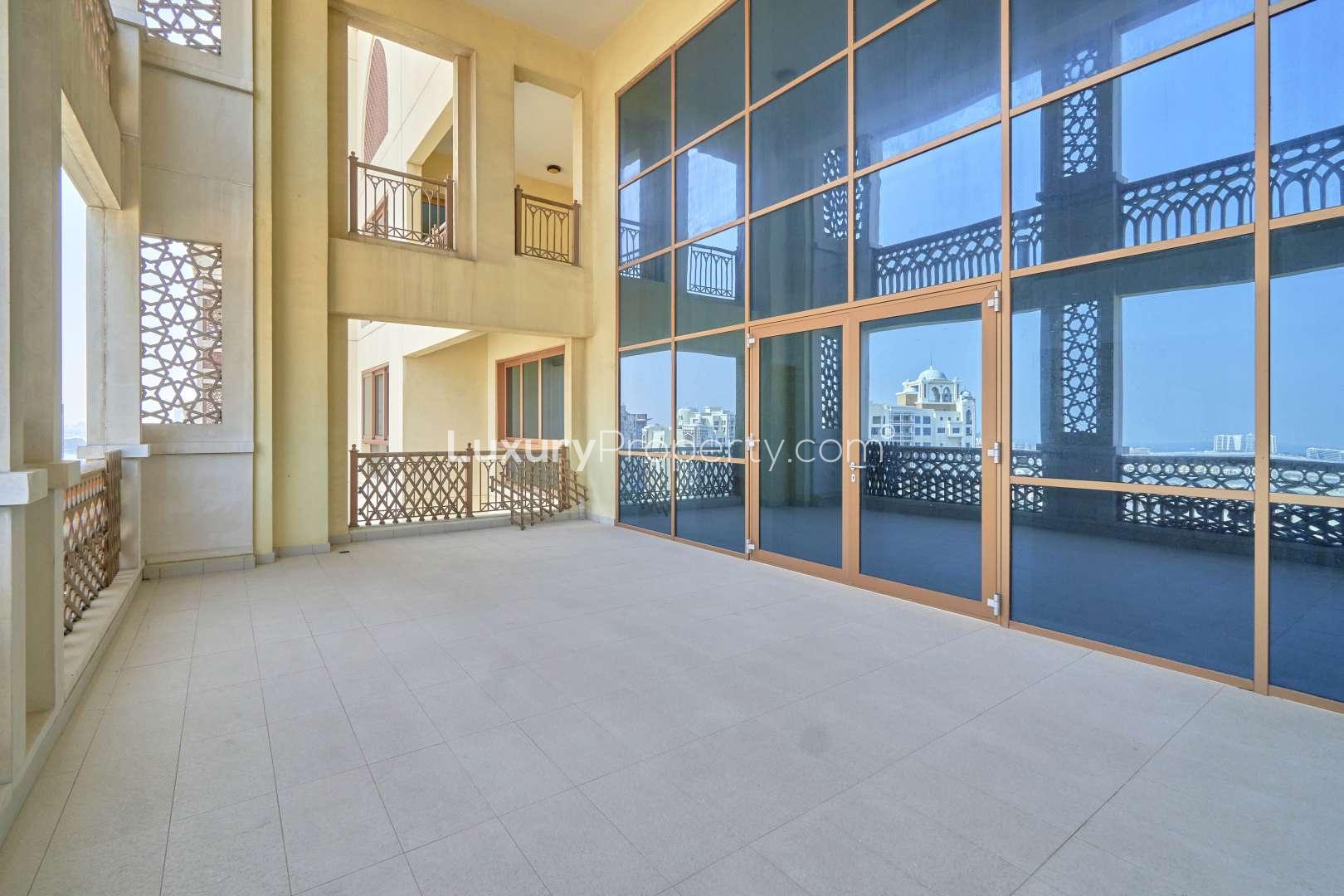 Empty room with wooden flooring and large windows in Palm Jumeirah penthouse, Marina Residences