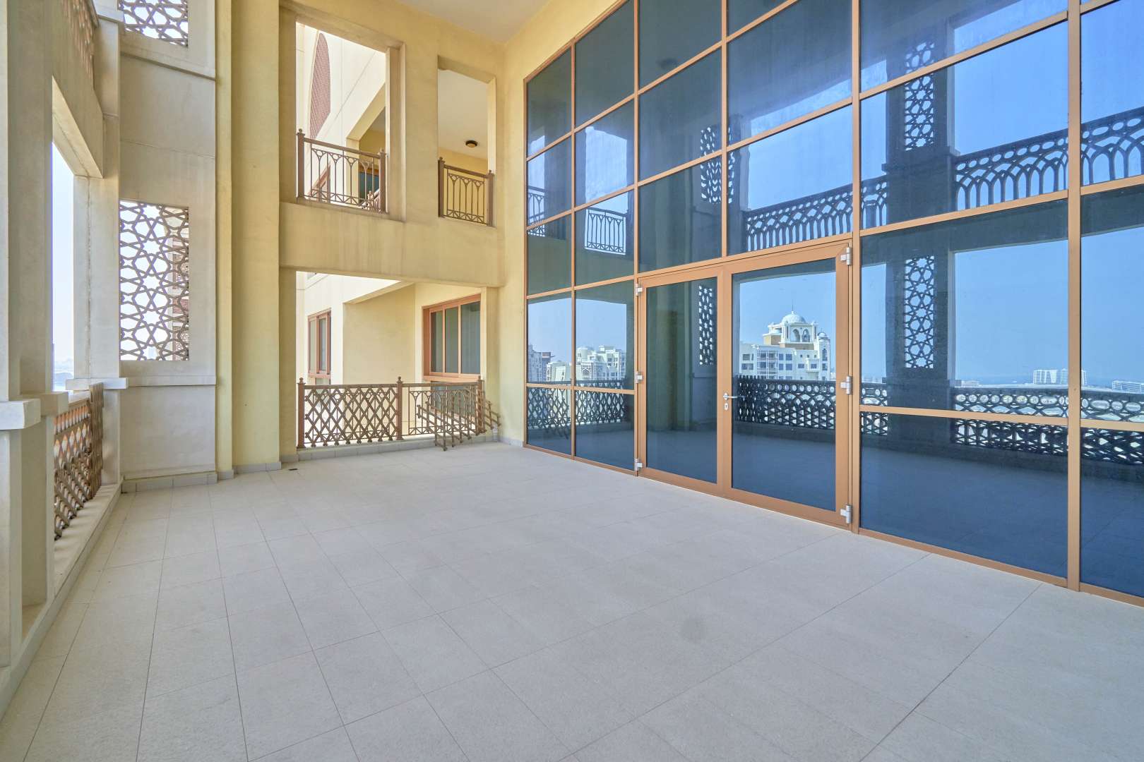 Empty room with wooden flooring and large windows in Palm Jumeirah penthouse, Marina Residences