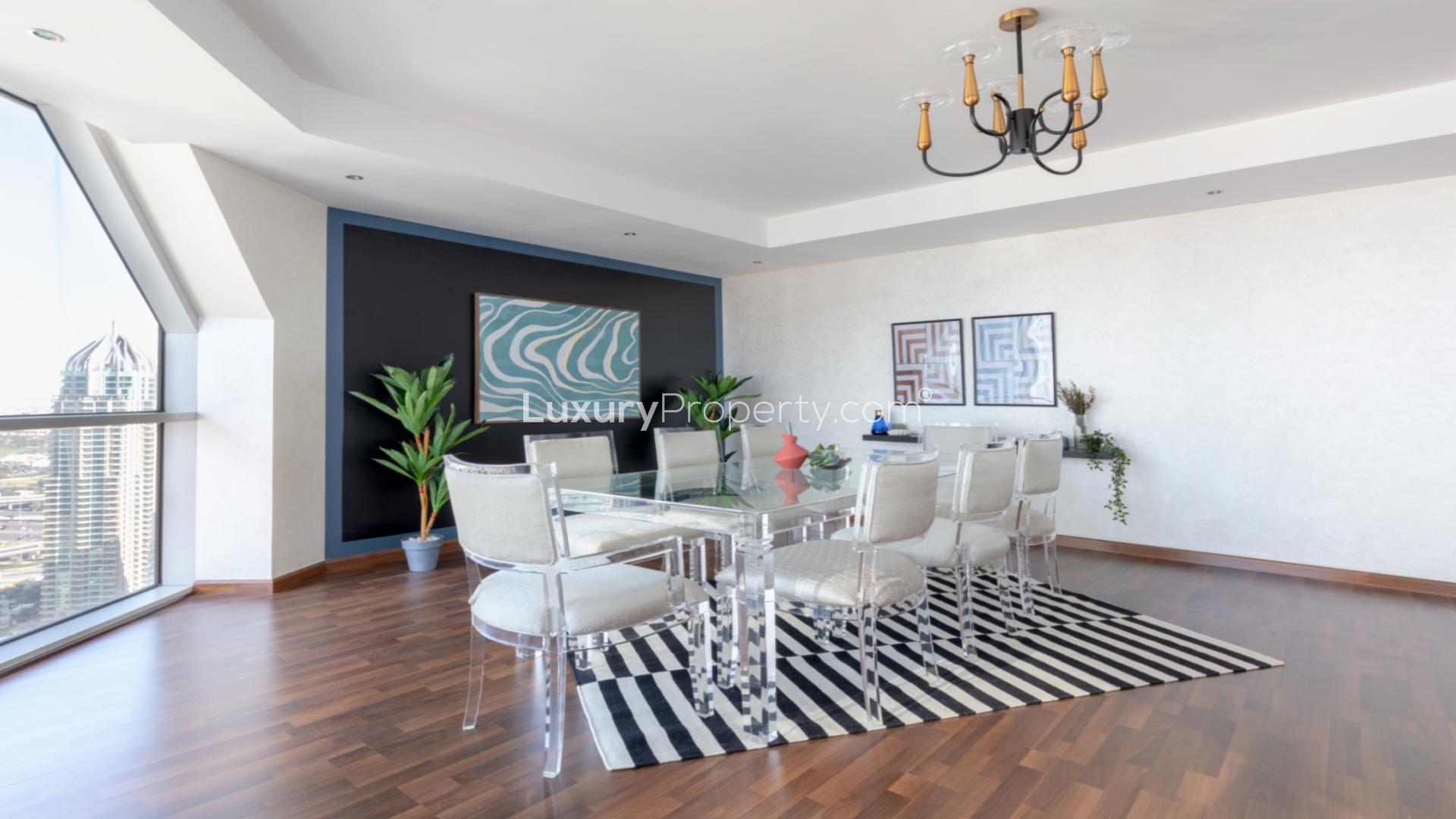 Bright living room in Dubai Marina penthouse with modern furniture and wooden flooring