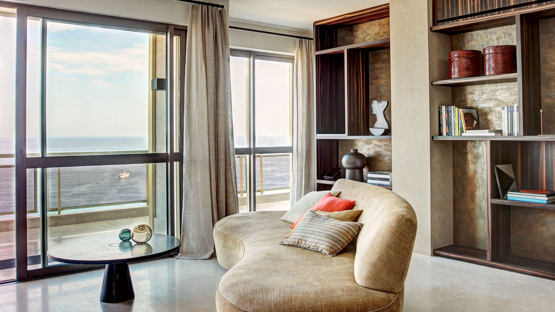 Modern living room in Larvotto penthouse, French Riviera, with stylish decor and art