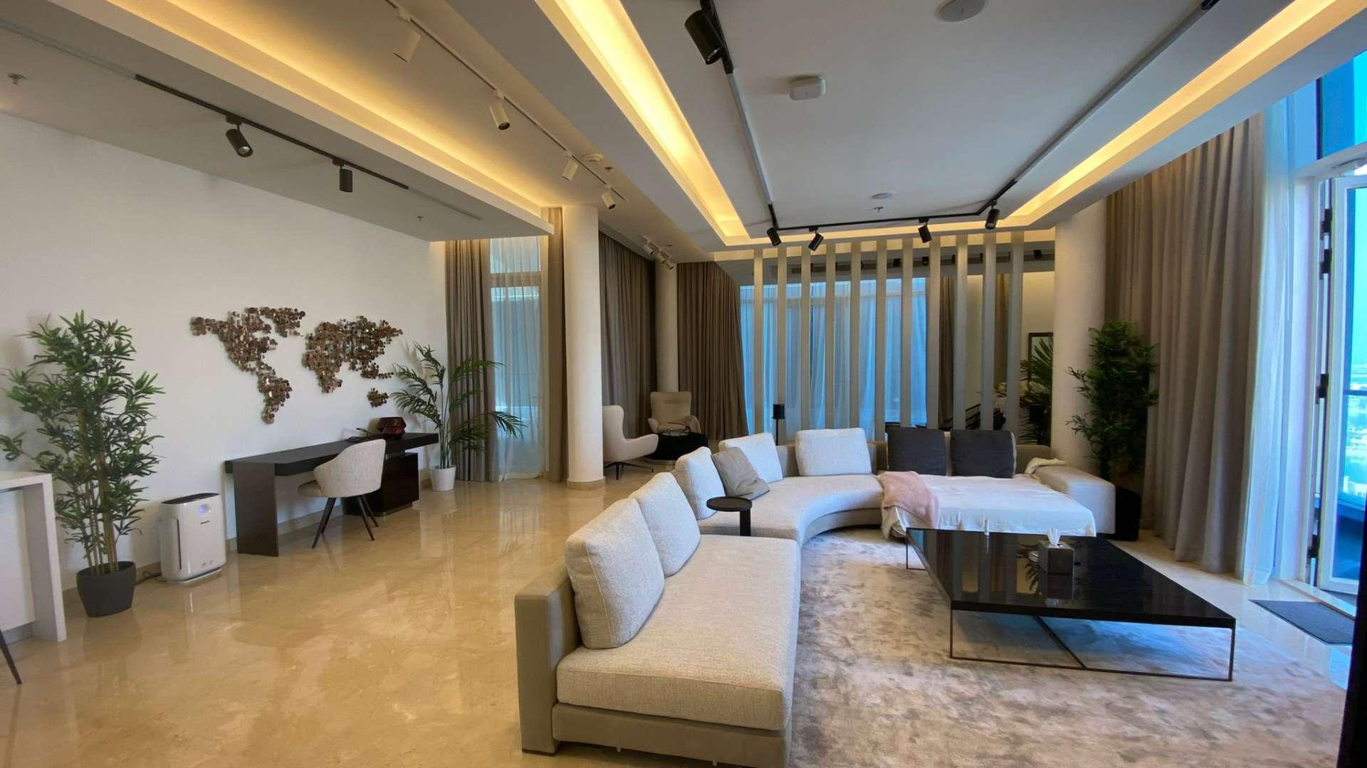 Penthouse view of Palm Jumeirah marina at sunset, overlooking luxury yachts and skyline