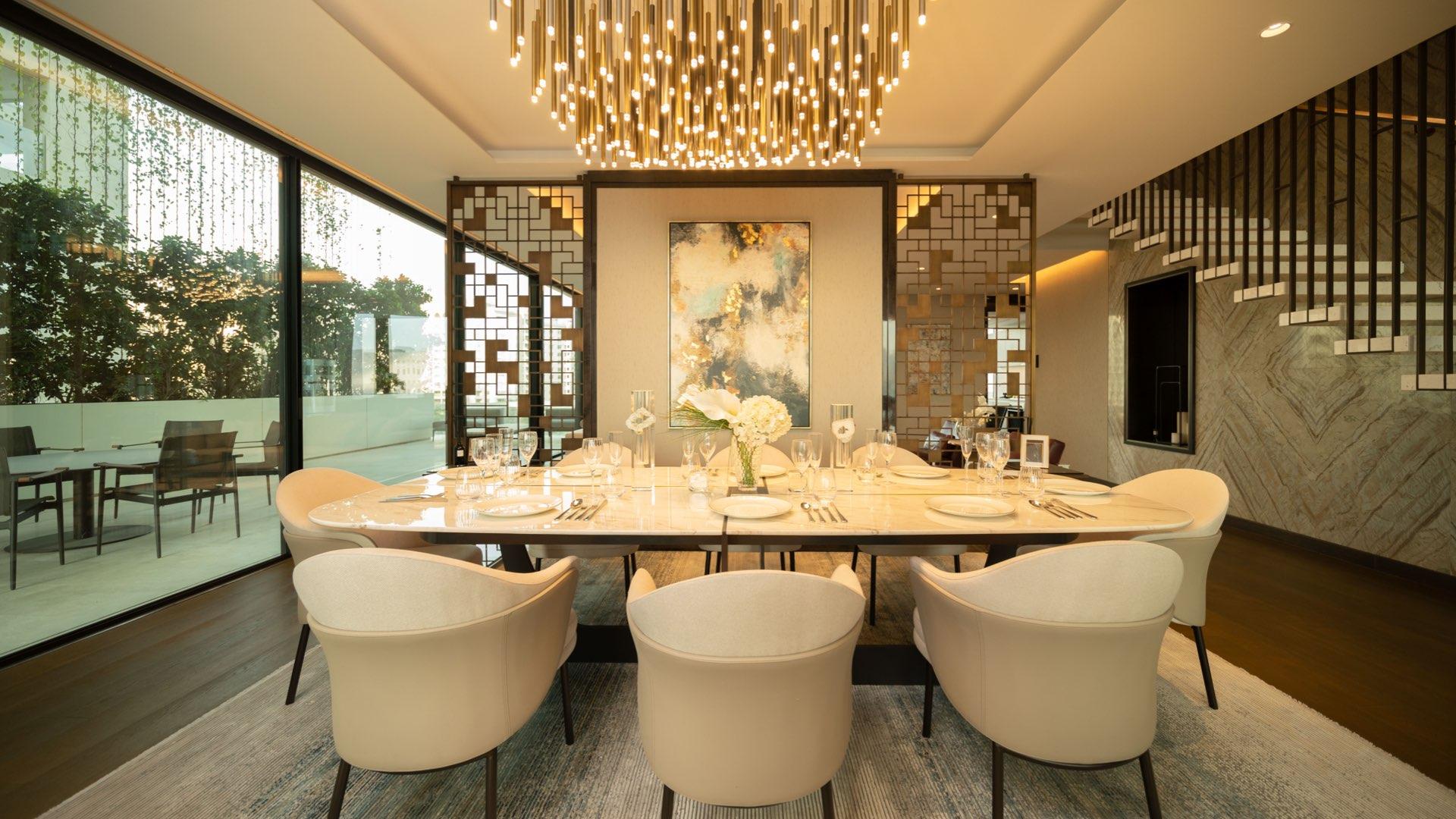 Luxurious dining area in One Palm penthouse, elegant decor and chandelier lighting