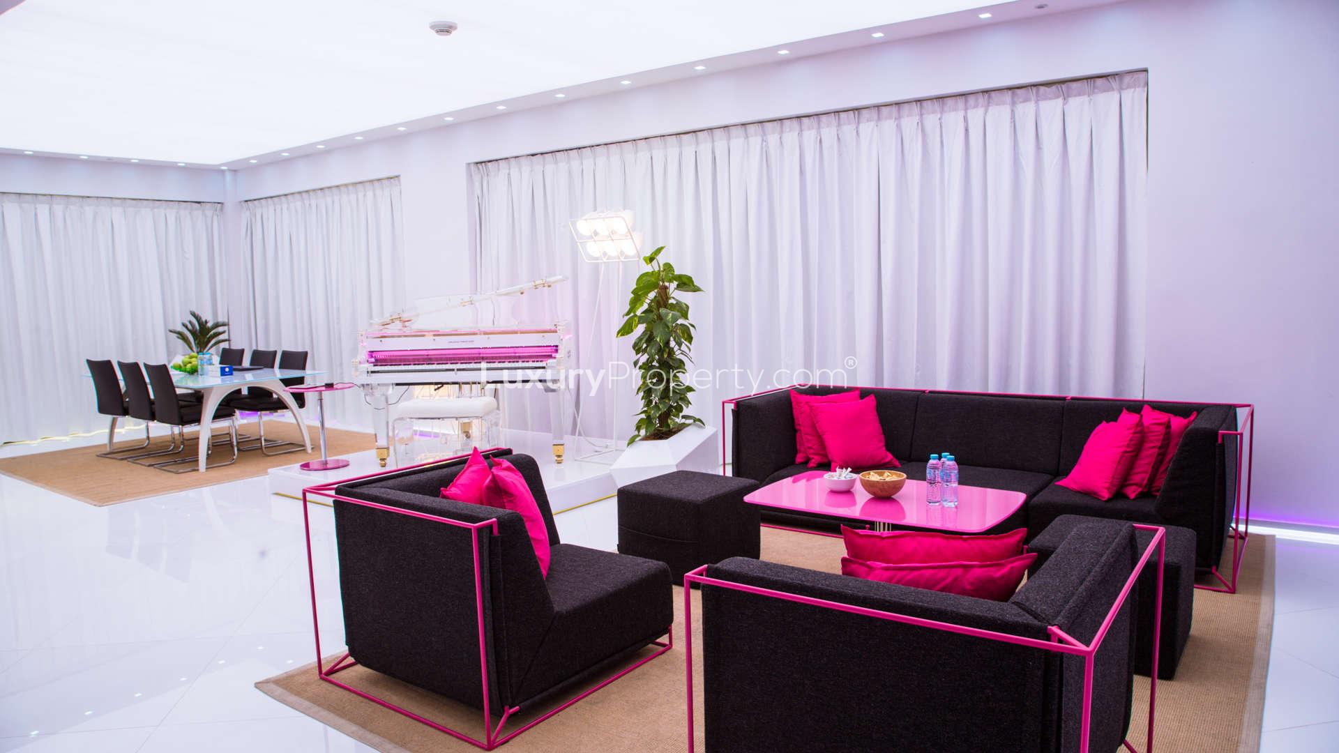 "Luxury Rimal penthouse terrace with sea view, Jumeirah Beach Residence, pink seating area.",Luxury penthouse living room with modern decor in Rimal, Jumeirah Beach Residence