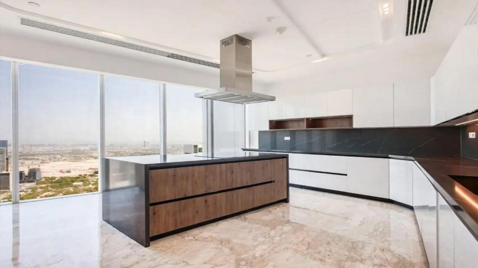 Luxurious dining area in Downtown Dubai penthouse, featuring modern decor and large windows