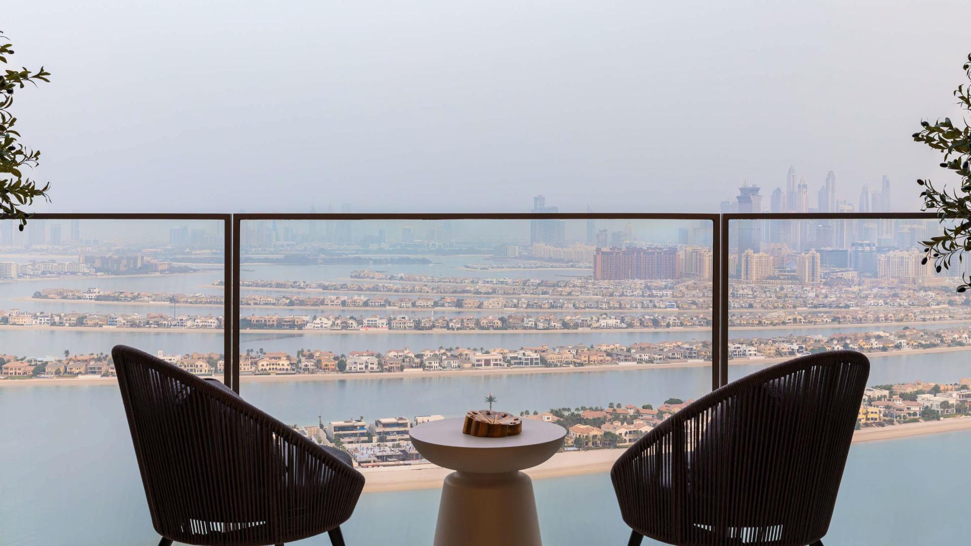 "Stunning Palm Jumeirah view from Atlantis The Royal penthouse balcony, luxury living experience.",Luxurious bedroom in Atlantis The Royal penthouse, Palm Jumeirah, with modern decor and shelving