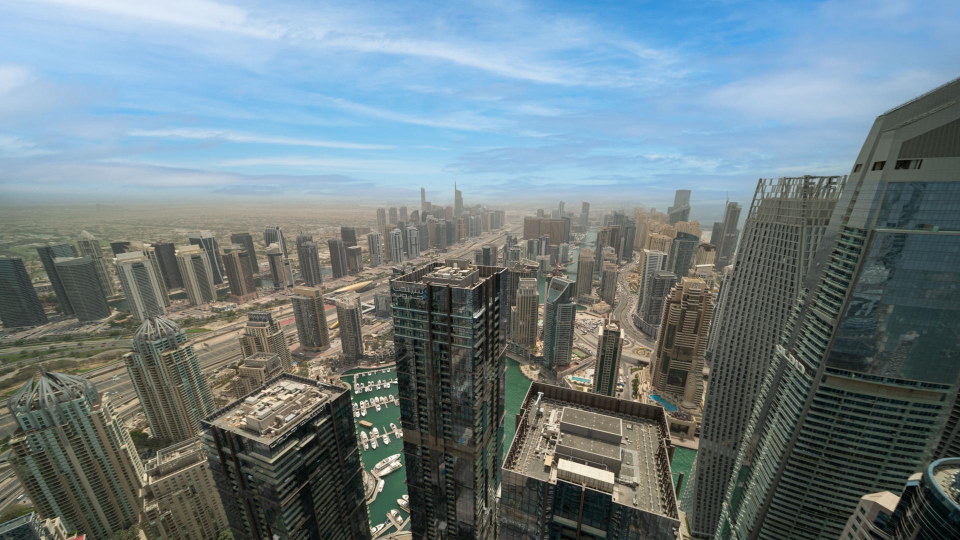 Aerial view of Dubai Marina skyline from elegant four-bedroom penthouse in The Torch