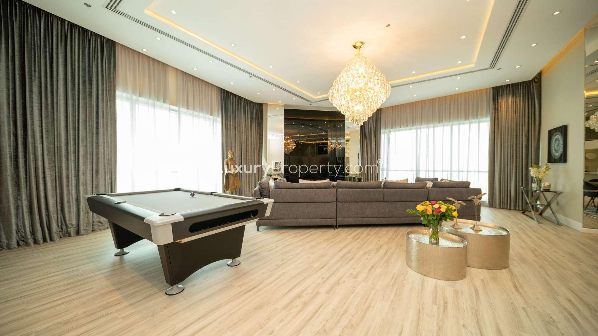 Luxurious living room in refurbished four-bedroom penthouse, Dubai Marina, featuring pool table