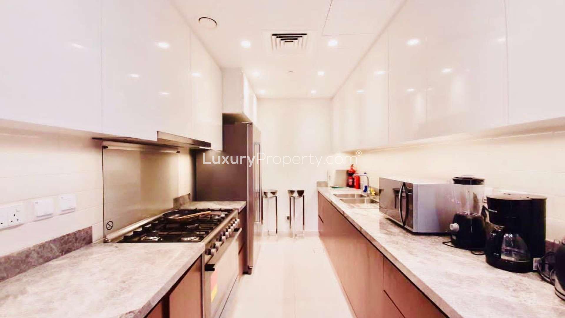 Contemporary living room in 4-bed penthouse, Downtown Dubai, featuring plush seating and city views